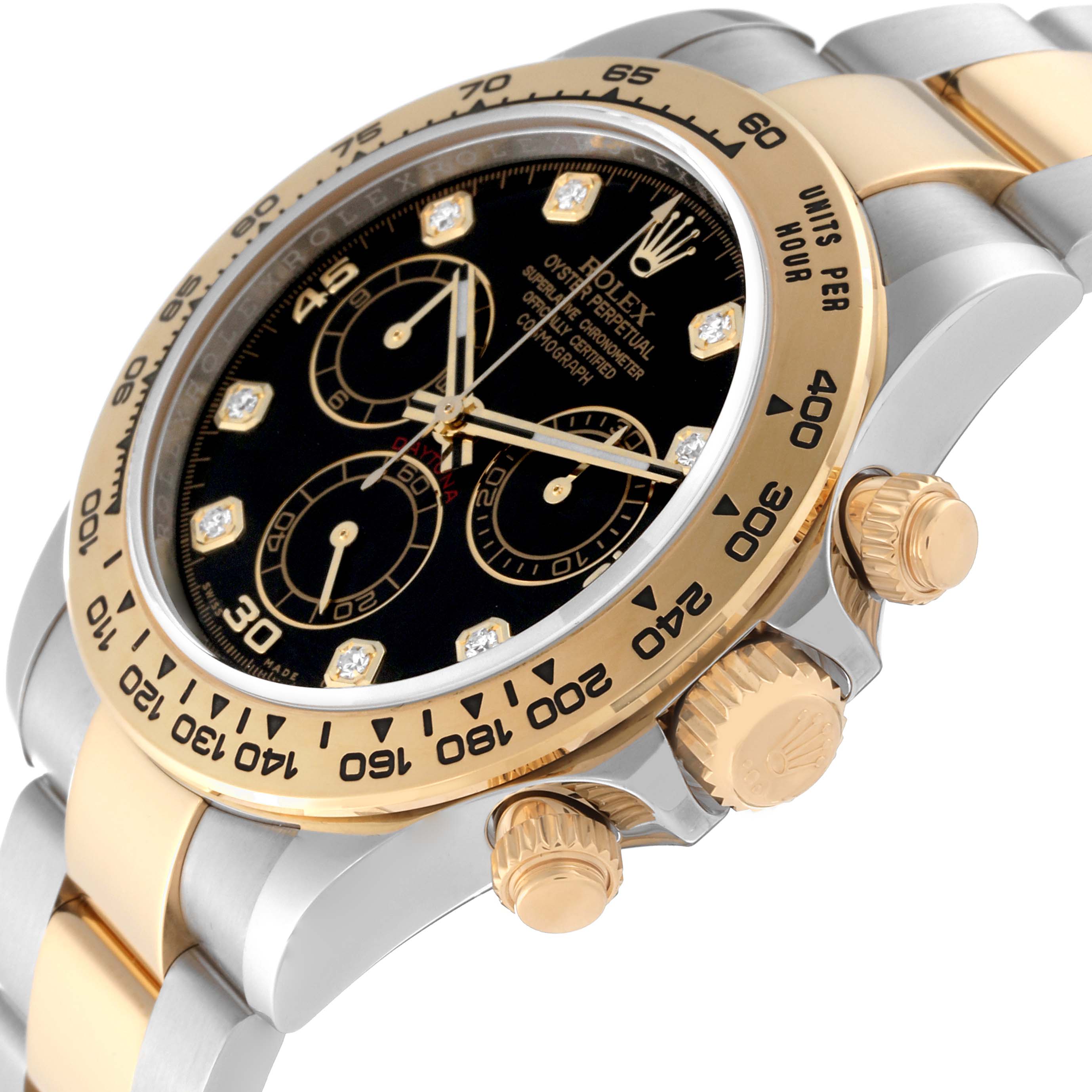 This image shows a close-up angle of a Rolex Daytona 116503 Men
s Steel and Gold (two tone) Black Dial 116503 Men
s Steel and Gold (two tone) Black Dial watch, focusing on its gold and silver bezel, dial, and pushers.