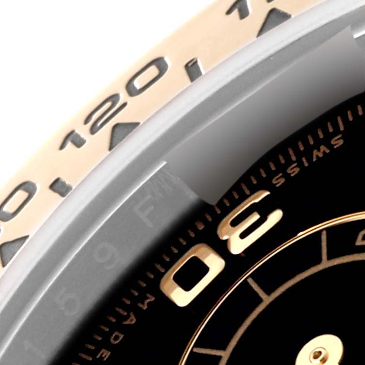 Close-up of a Rolex Daytona 116503 Men
s Steel and Gold (two tone) Black Dial 116503 Men
s Steel and Gold (two tone) Black Dial watch showing the bezel with engraved minute markers and a portion of the dial with "30" and "Swiss Made".