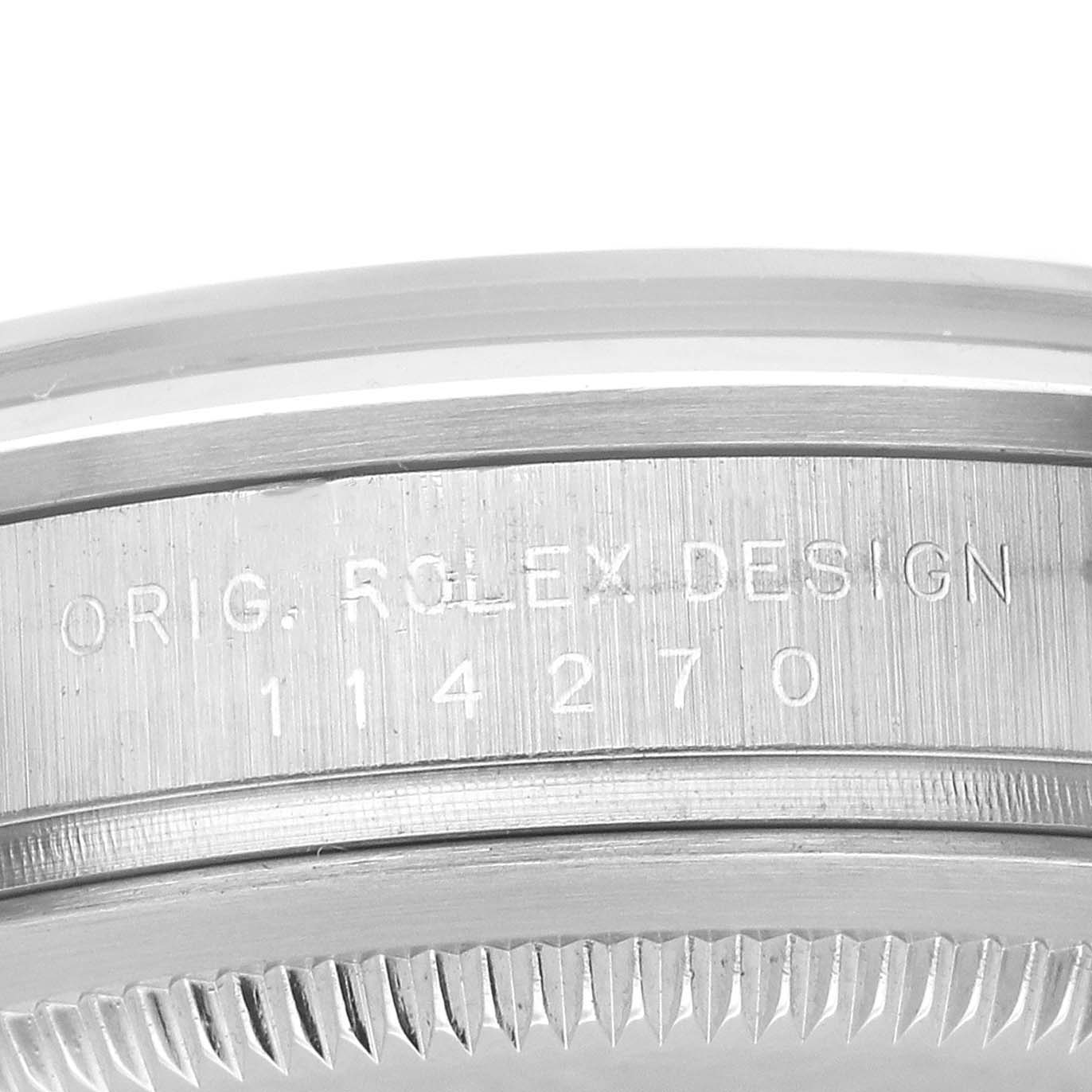 The image shows a close-up of the side of a Rolex Explorer 114270 Men's Stainless Steel Black Dial watch case with engraved model details.