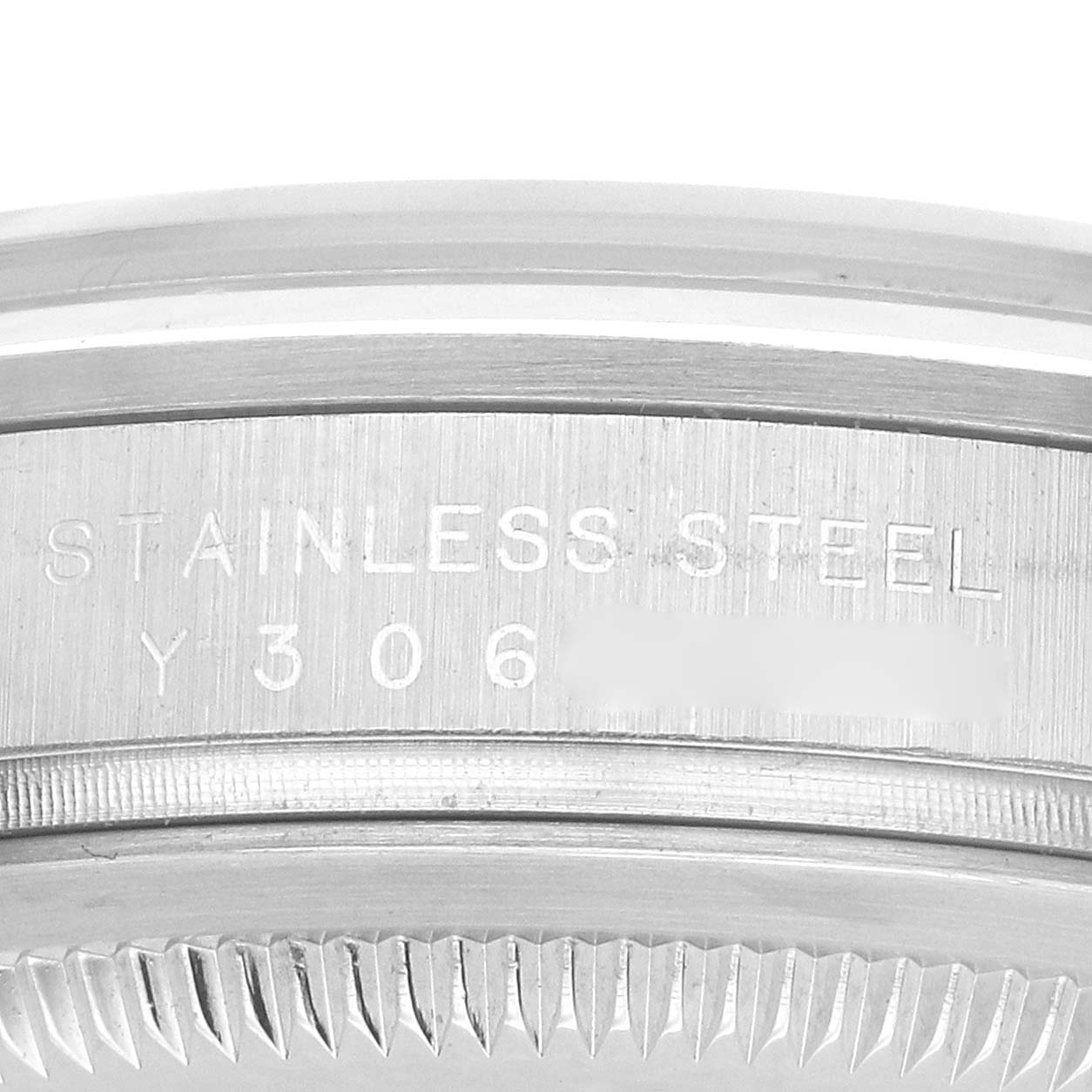 The image shows a close-up of the side edge and part of the case back of a Rolex Explorer 114270 Men's Stainless Steel Black Dial, focusing on the stainless steel engraving.