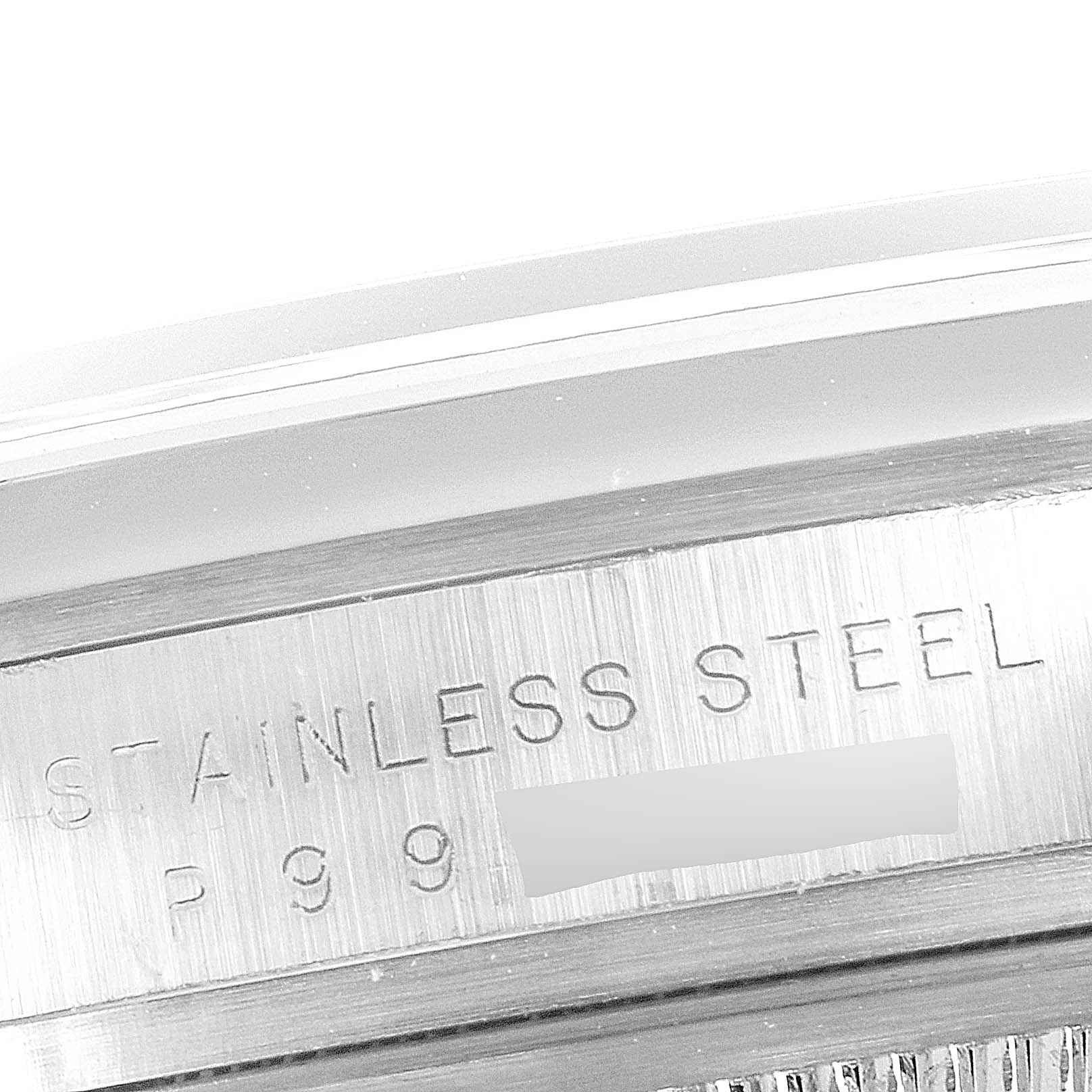 This image shows a close-up of the side engraving on a Rolex Explorer 114270 Men's Stainless Steel Black Dial 114270 Men's Stainless Steel Black Dial model watch, featuring "STAINLESS STEEL" and partial numbers.