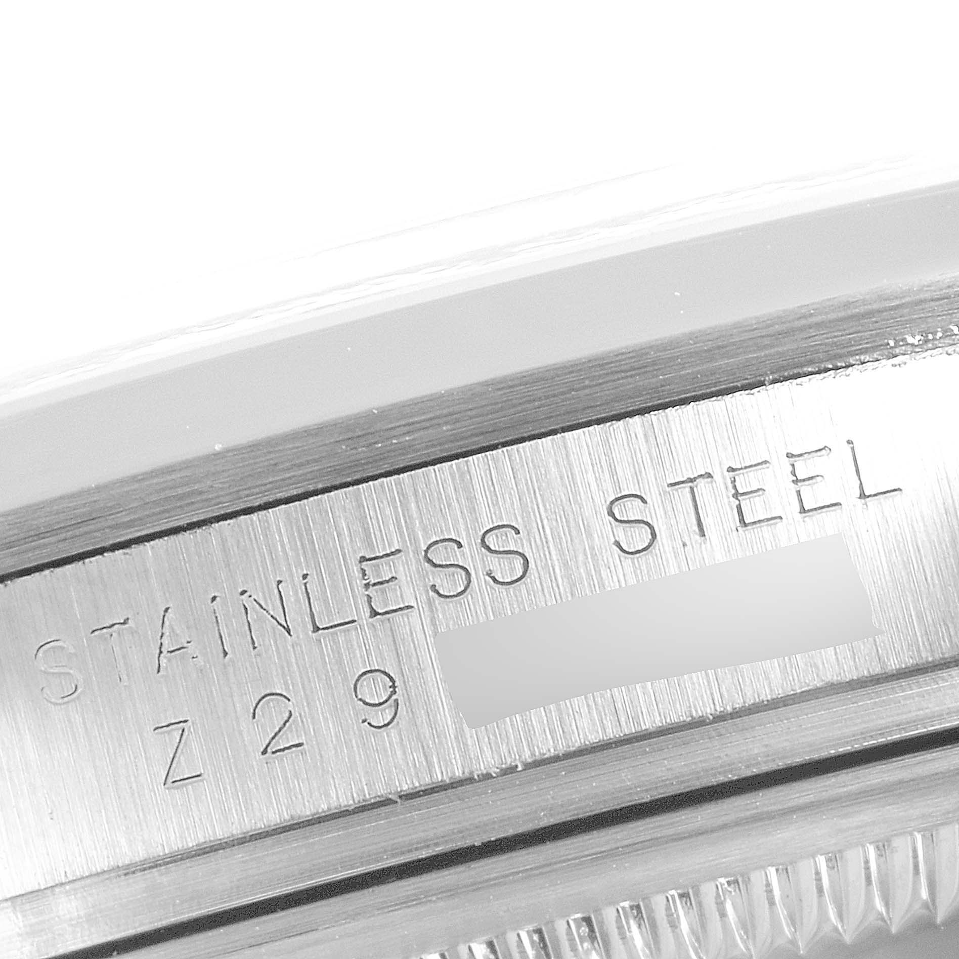 This is a close-up of the side of the stainless steel case of the Rolex Explorer 114270 Men's Stainless Steel Black Dial 114270 Men's Stainless Steel Black Dial watch, showing part of the serial number.