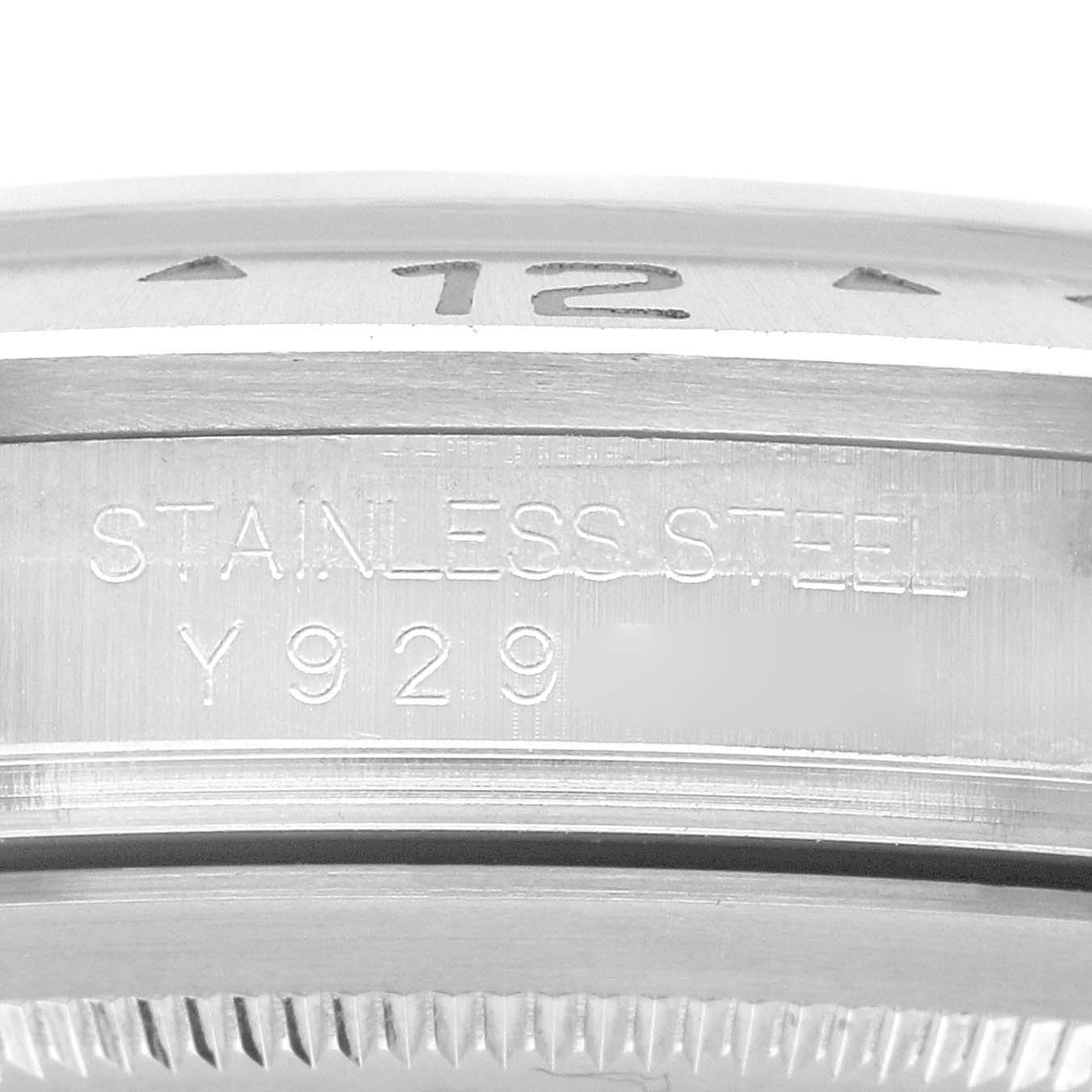The image shows a close-up of the side engraving on a Rolex Explorer 16570 Men's Stainless Steel Black Dial watch case, highlighting "STAINLESS STEEL Y929."