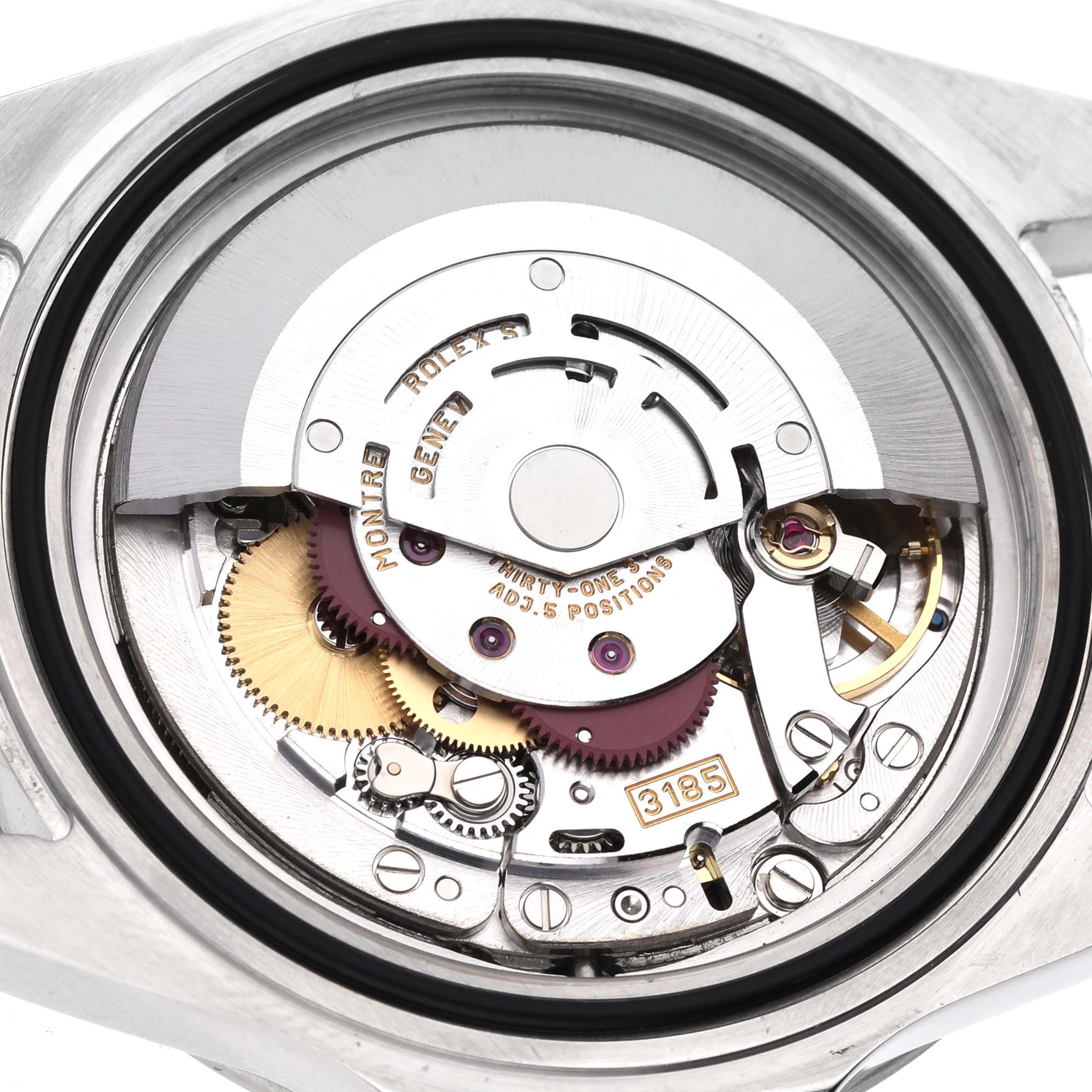The image shows the internal mechanism of the Rolex Explorer 16570 Men's Stainless Steel Black Dial watch, highlighting gears, jewels, and the rotor from a top view.