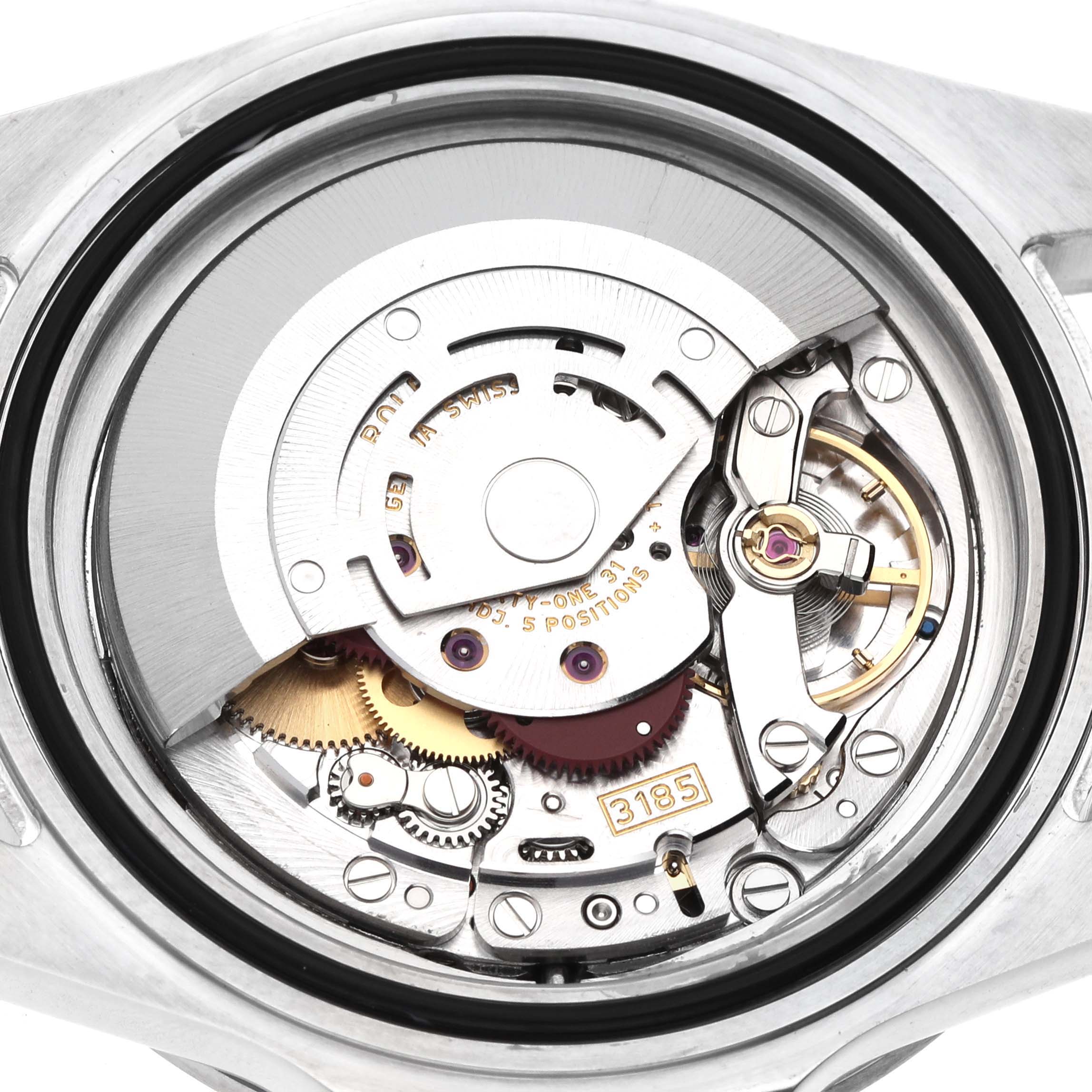 The image shows the internal movement of a Rolex Explorer 16570 Men's Stainless Steel Black Dial watch, featuring visible gears and mechanisms from a top-down angle.