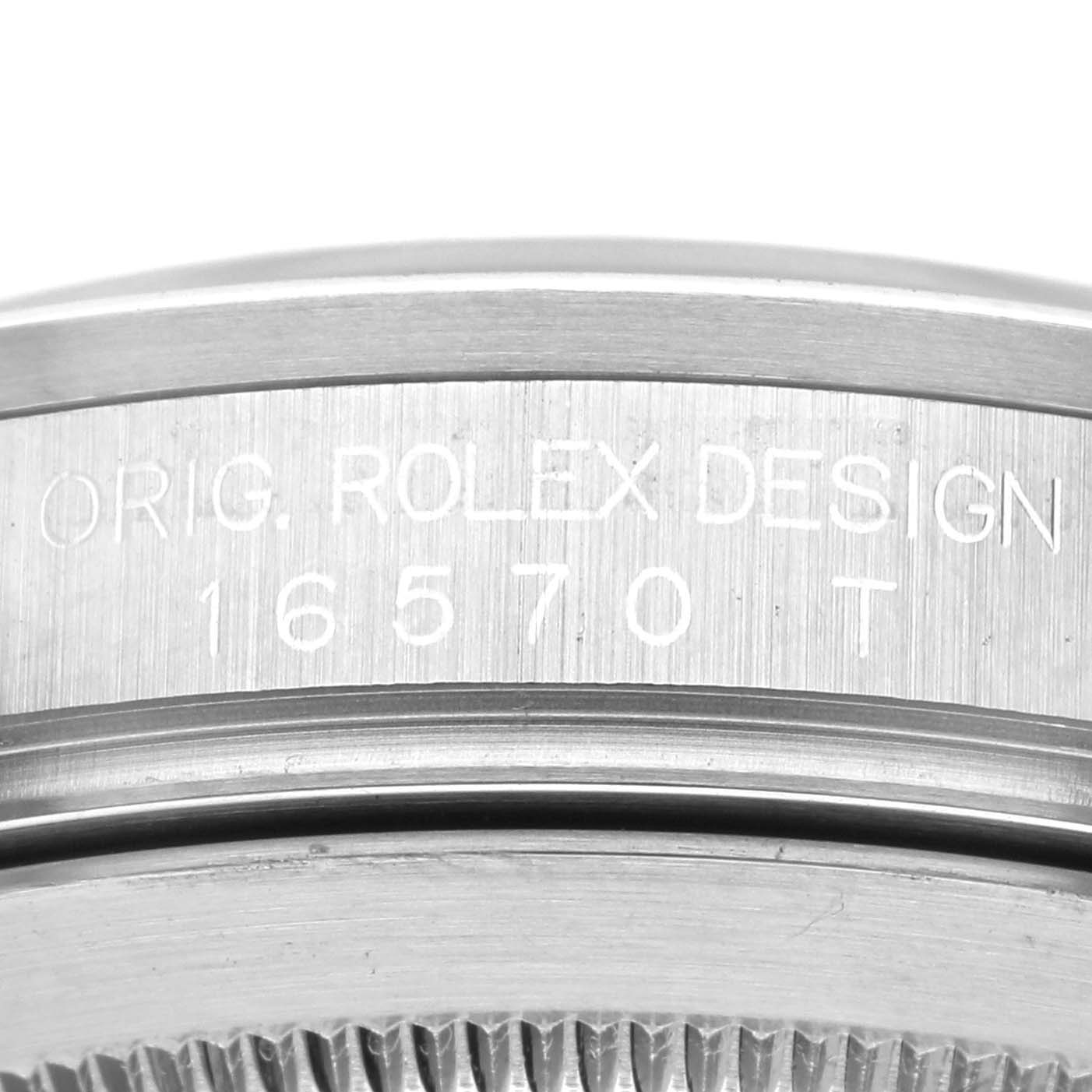 This image shows the side profile of the bezel and case of a Rolex Explorer 16570 Men
s Stainless Steel Black Dial 16570 Men
s Stainless Steel Black Dial watch, featuring the engraved model number 16570 T.