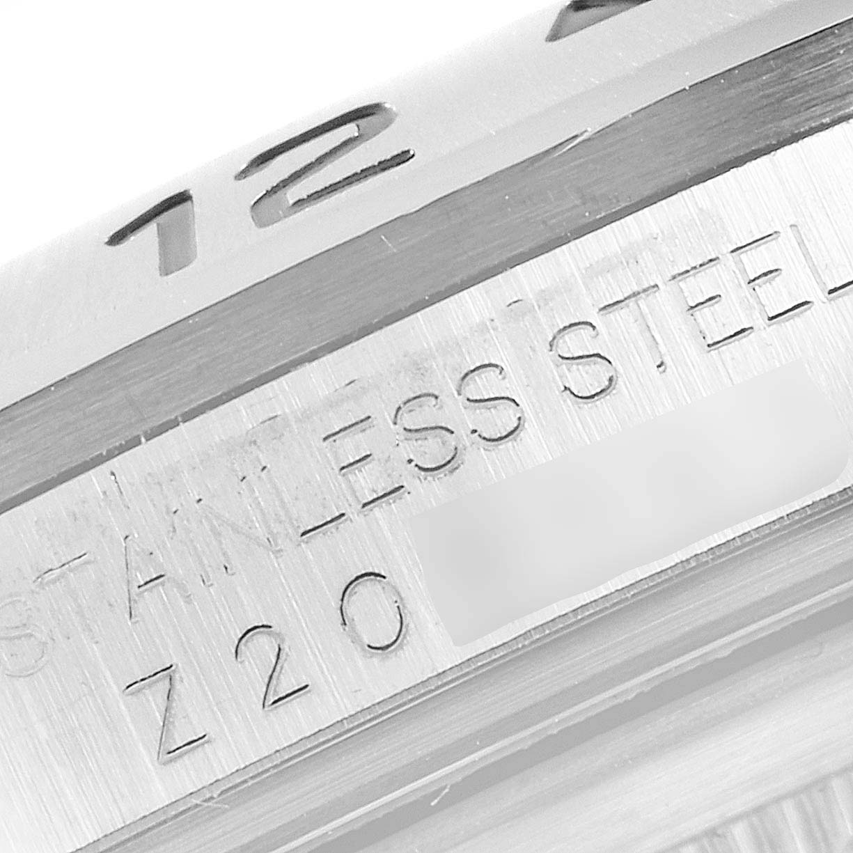 The image shows a close-up of the bezel and part of the case back with "STAINLESS STEEL" engraved on a Rolex Explorer 16570 Men's Stainless Steel White Dial 16570 Men's Stainless Steel White Dial watch.