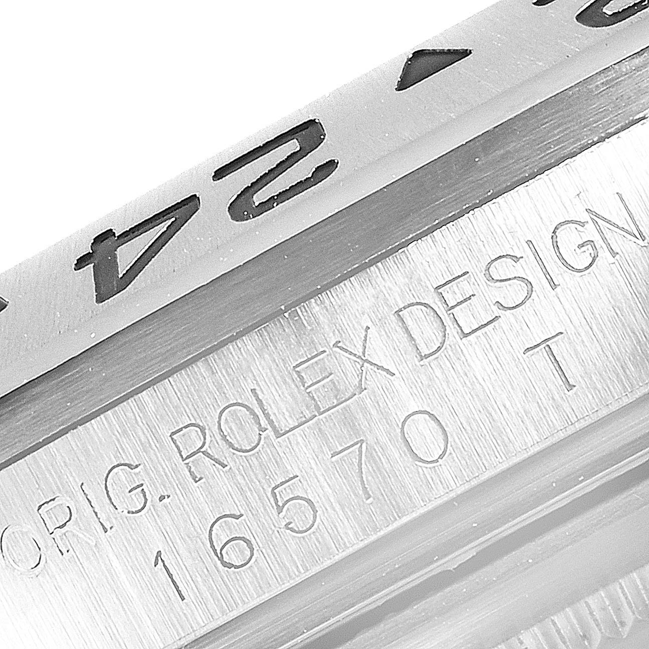 The image shows a close-up of the bezel and engraved side of a Rolex Explorer 16570 Men's Stainless Steel White Dial 16570 Men's Stainless Steel White Dial model 16570 watch.