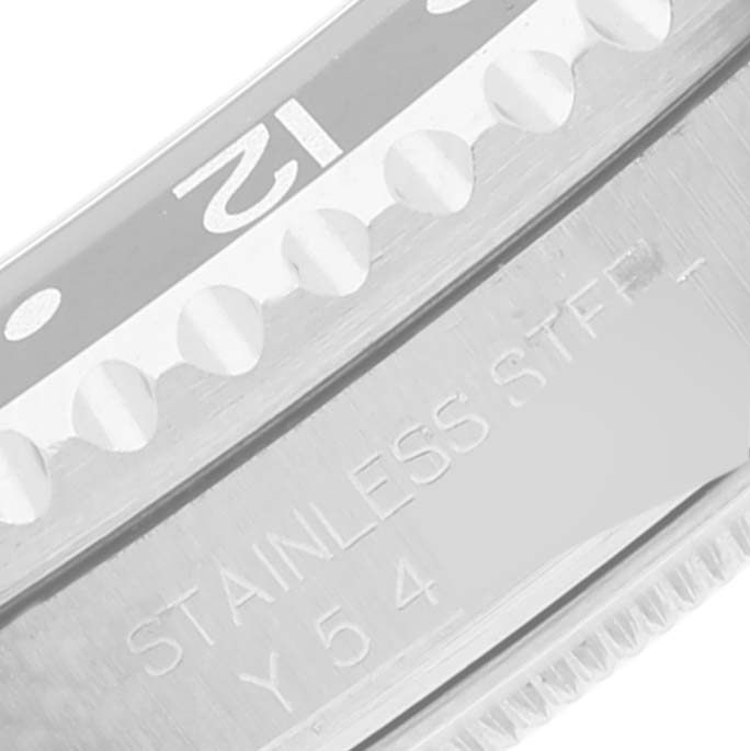 The image shows a close-up of the bezel and part of the case of a Rolex GMT-Master 16710 Men's Stainless Steel Black Dial 16710 Men's Stainless Steel Black Dial watch, highlighting the "12" marker and stainless steel engraving.