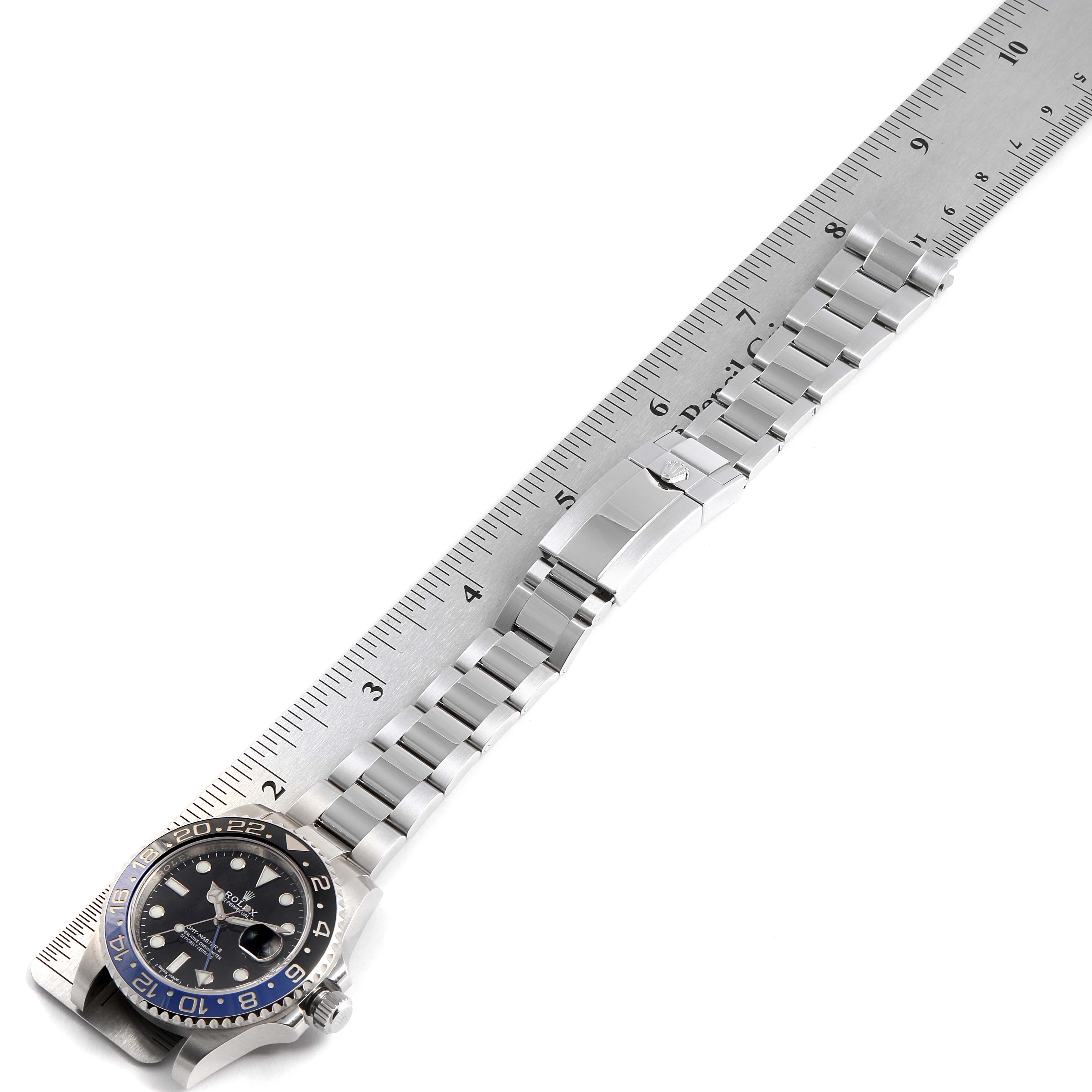 The Rolex GMT-Master 116710 Men's Stainless Steel Black Dial 116710 Men's Stainless Steel Black Dial watch is shown from an overhead angle, displaying its full bracelet and bezel alongside a ruler for measurement.