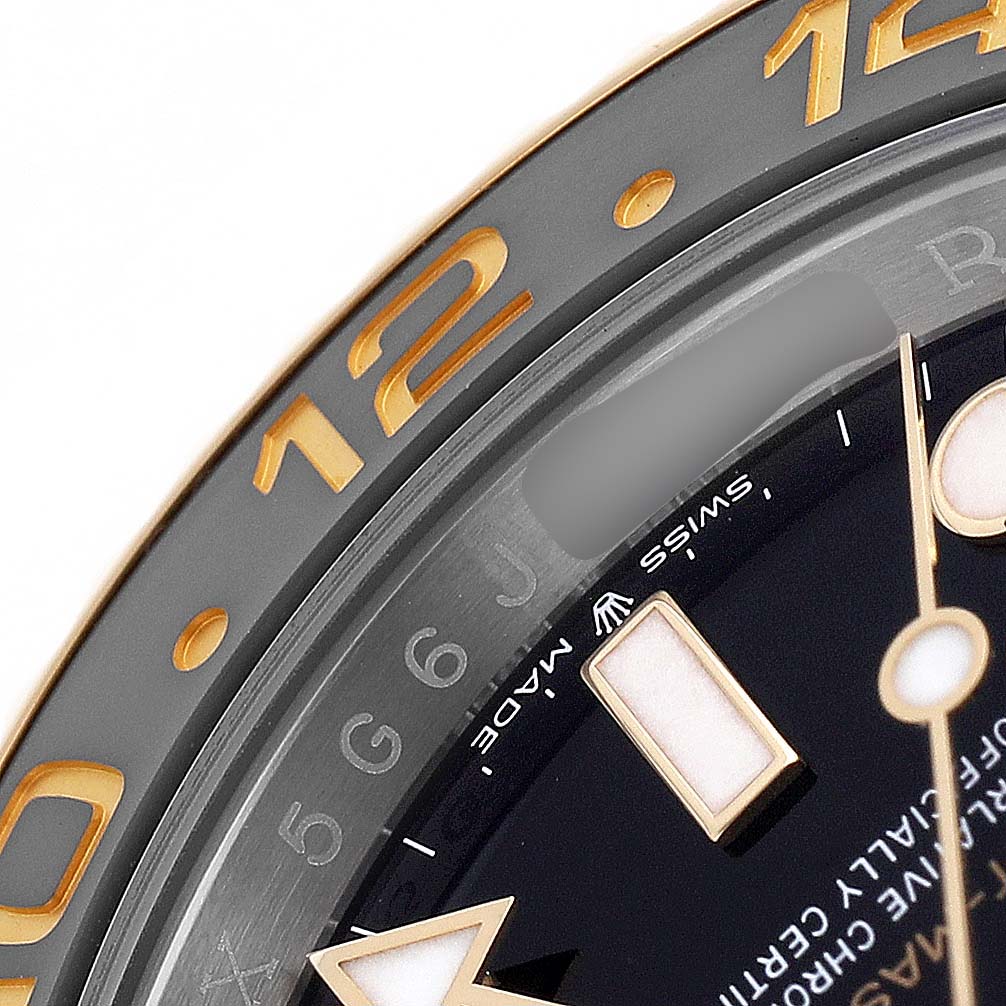 The image shows a close-up of the bezel and dial edge of a Rolex GMT-Master 126713GRNR Men's Steel and Gold (two tone) Black Dial watch, highlighting the numerals and markers.