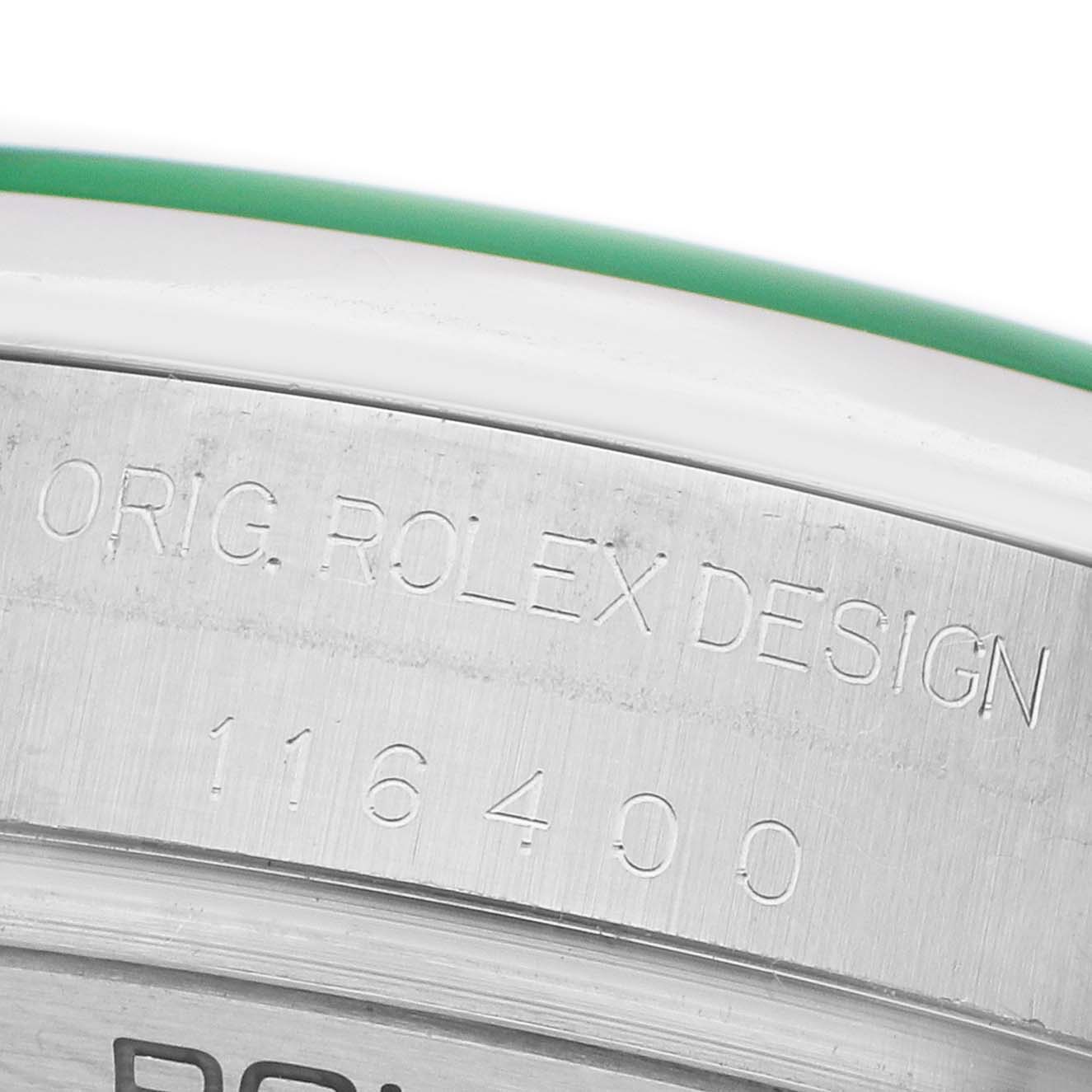 The image shows a close-up of the edge of a Rolex Milgauss 116400 Men's Stainless Steel Blue Dial watch case, featuring the model number and "ORIG. ROLEX DESIGN" engraving.