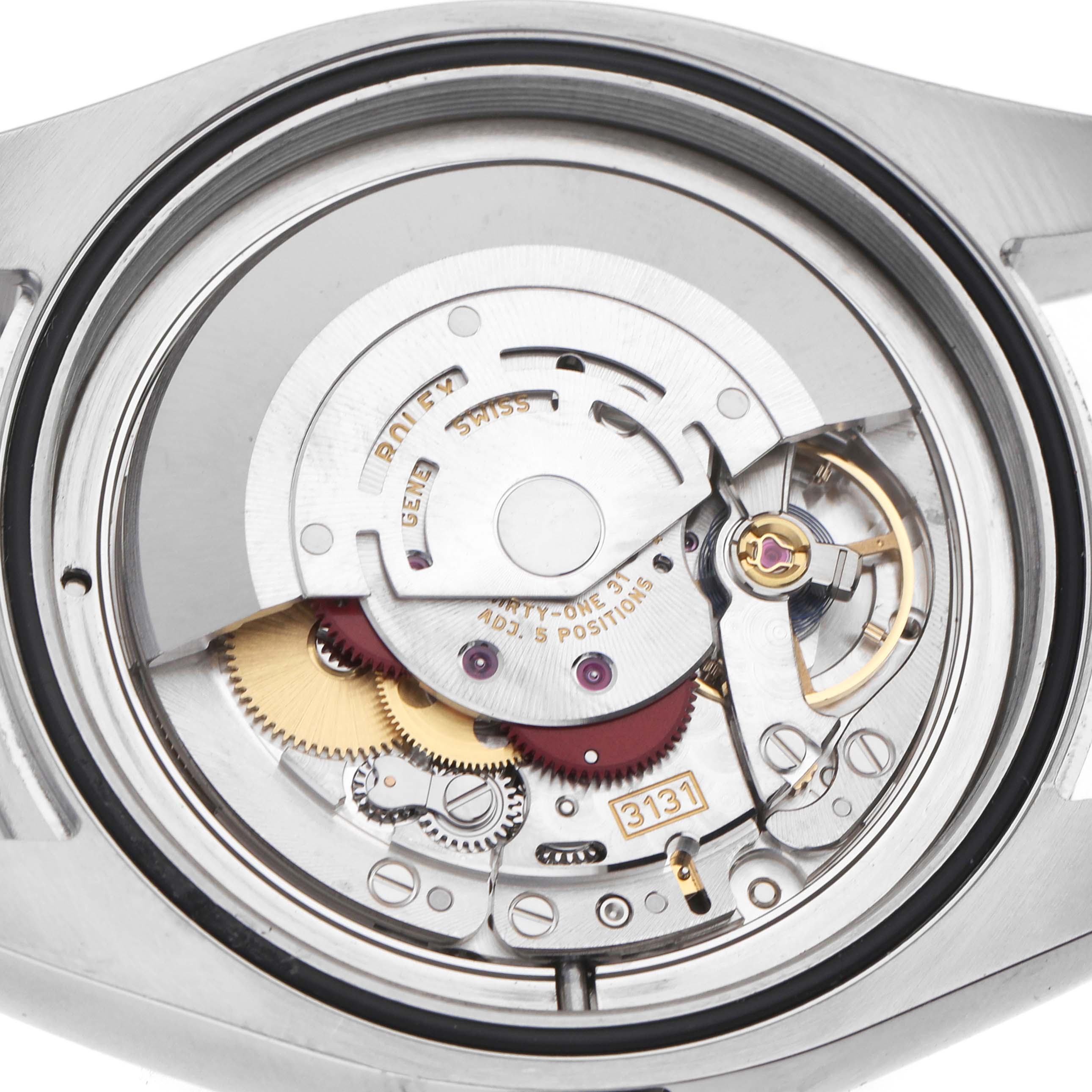 The image shows the Rolex Milgauss 116400 Men's Stainless Steel Blue Dial watch from a rear angle, highlighting its intricate internal mechanical movement.