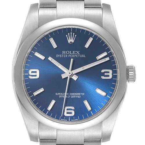 The image shows a front view of a Rolex Oyster Perpetual watch featuring a blue dial and stainless steel bracelet.