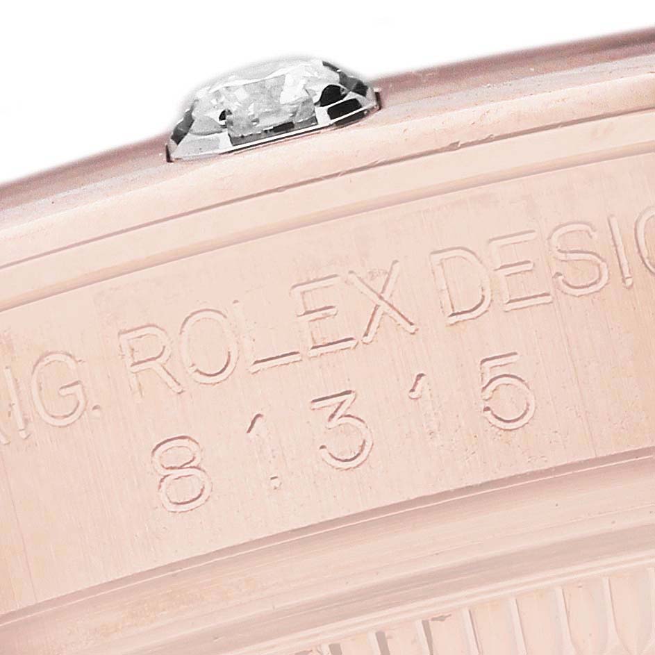 This close-up image shows the side engraving and a diamond of a Rolex Pearlmaster 81315 Women's Rose Gold Brown Dial 81315 Women's Rose Gold Brown Dial watch.