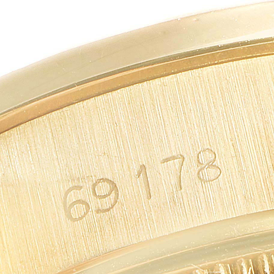 This close-up image shows the case back or interior of the case of a Rolex President 69178 Women
s Yellow Gold Champagne Dial 69178 Women
s Yellow Gold Champagne Dial model, featuring a serial number engraving.