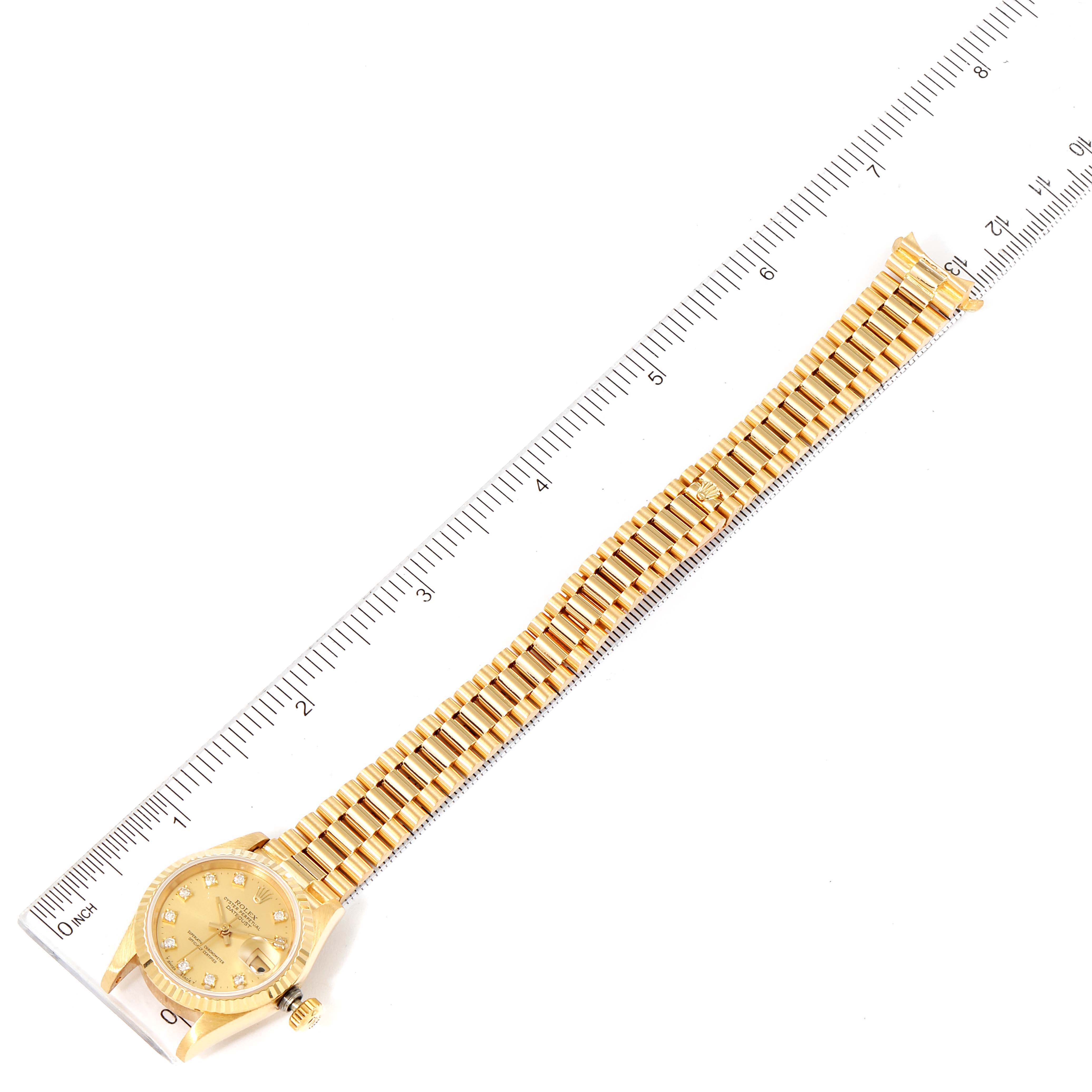 This image shows a Rolex President 69178 Women's Yellow Gold Champagne Dial 69178 Women's Yellow Gold Champagne Dial model wristwatch laid flat next to a ruler, displaying the watch dial, case, and bracelet.