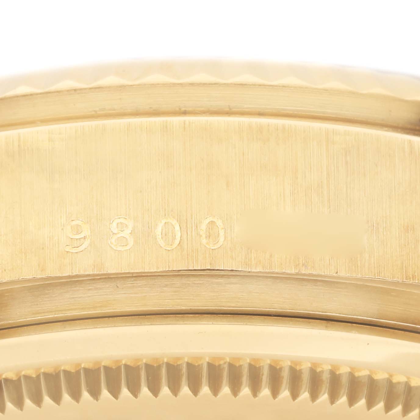 This image shows a close-up of the serial number engraving on the side of the case of a Rolex President 18038 Men
s Yellow Gold Champagne Dial 18038 Men
s Yellow Gold Champagne Dial model.