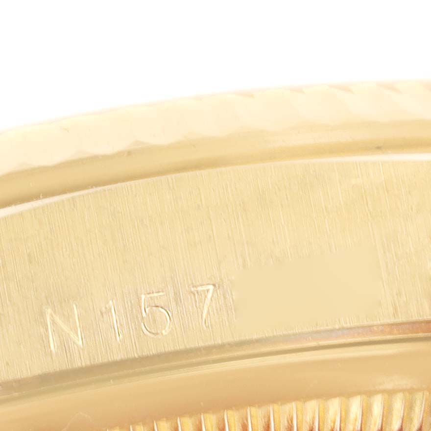 This close-up image shows the edge and part of the case-back of a Rolex President 18338 Men's Yellow Gold Champagne Dial 18338 Men's Yellow Gold Champagne Dial model watch, featuring the engraving "N157."