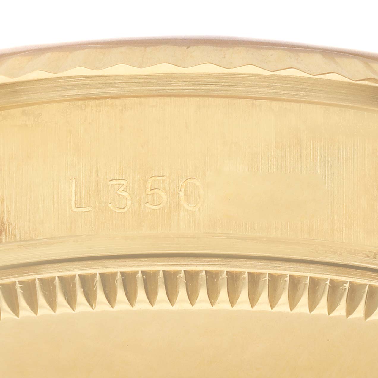The image shows an engraved part of a Rolex President 68278 Women
s Yellow Gold Champagne Dial 68278 Women
s Yellow Gold Champagne Dial model watch, specifically the inner bezel with the serial number "L350."