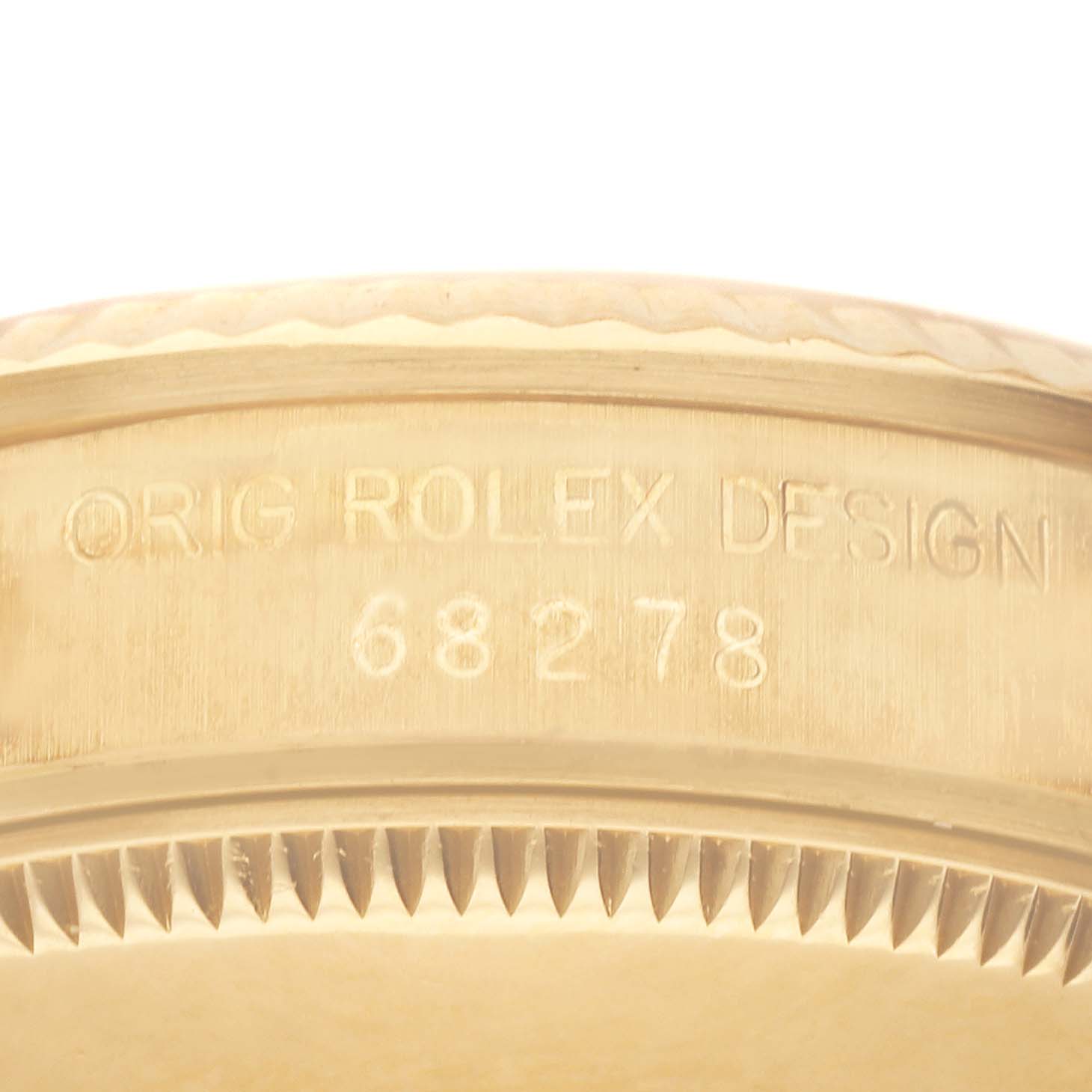 This image shows a close-up of the side of a Rolex President 68278 Women
s Yellow Gold Champagne Dial 68278 Women
s Yellow Gold Champagne Dial model watch, highlighting the engraving "ORIG ROLEX DESIGN 68278."