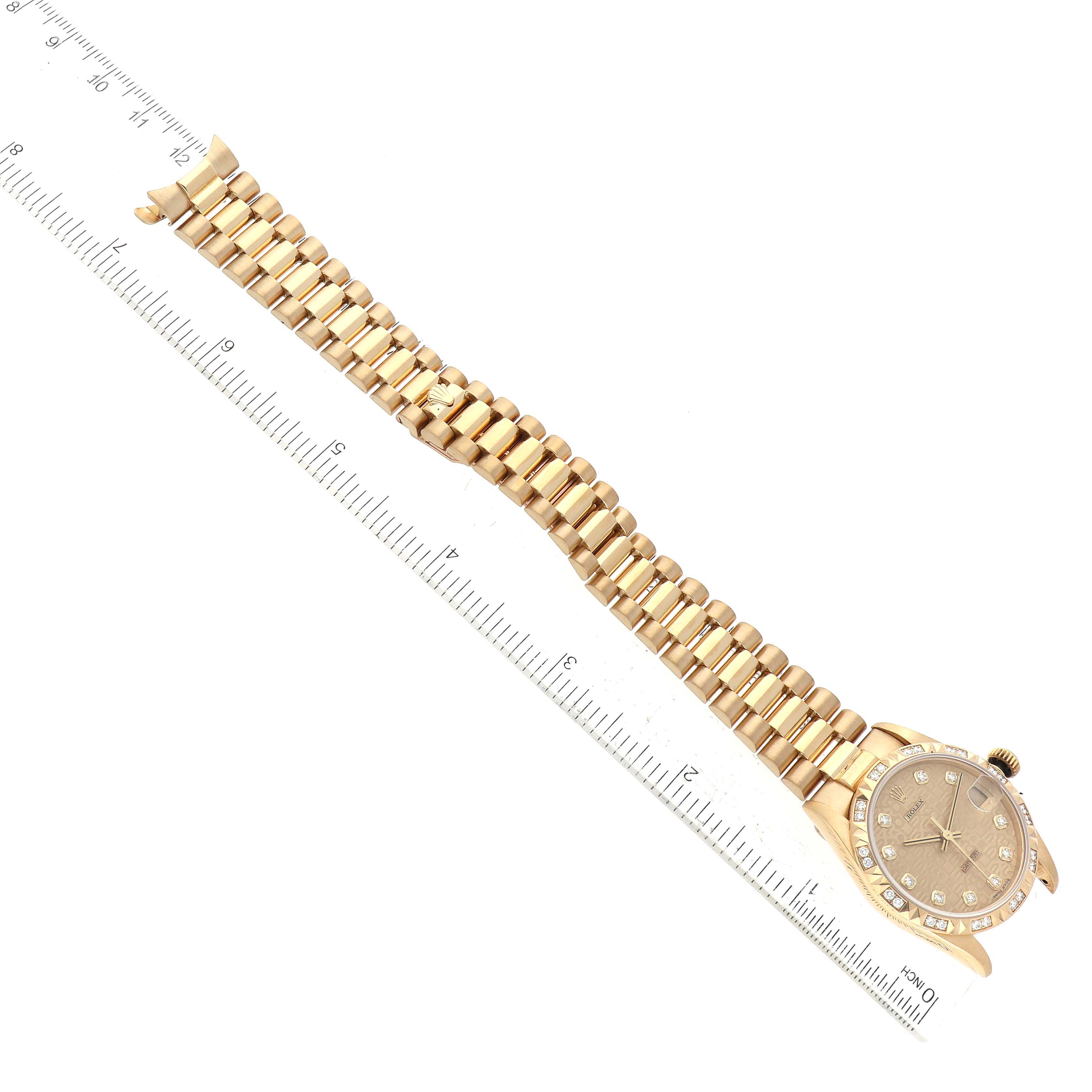 This image shows the Rolex President 68258 Women's Yellow Gold Champagne Dial 68258 Women's Yellow Gold Champagne Dial model watch laid flat, aligned with a ruler for scale.