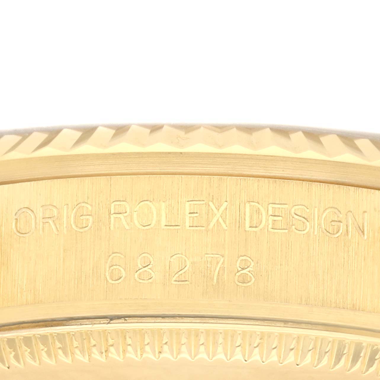 This close-up image shows the engraved edge of the bezel and case of the Rolex President 68278 Women's Yellow Gold Champagne Dial 68278 Women's Yellow Gold Champagne Dial model watch.