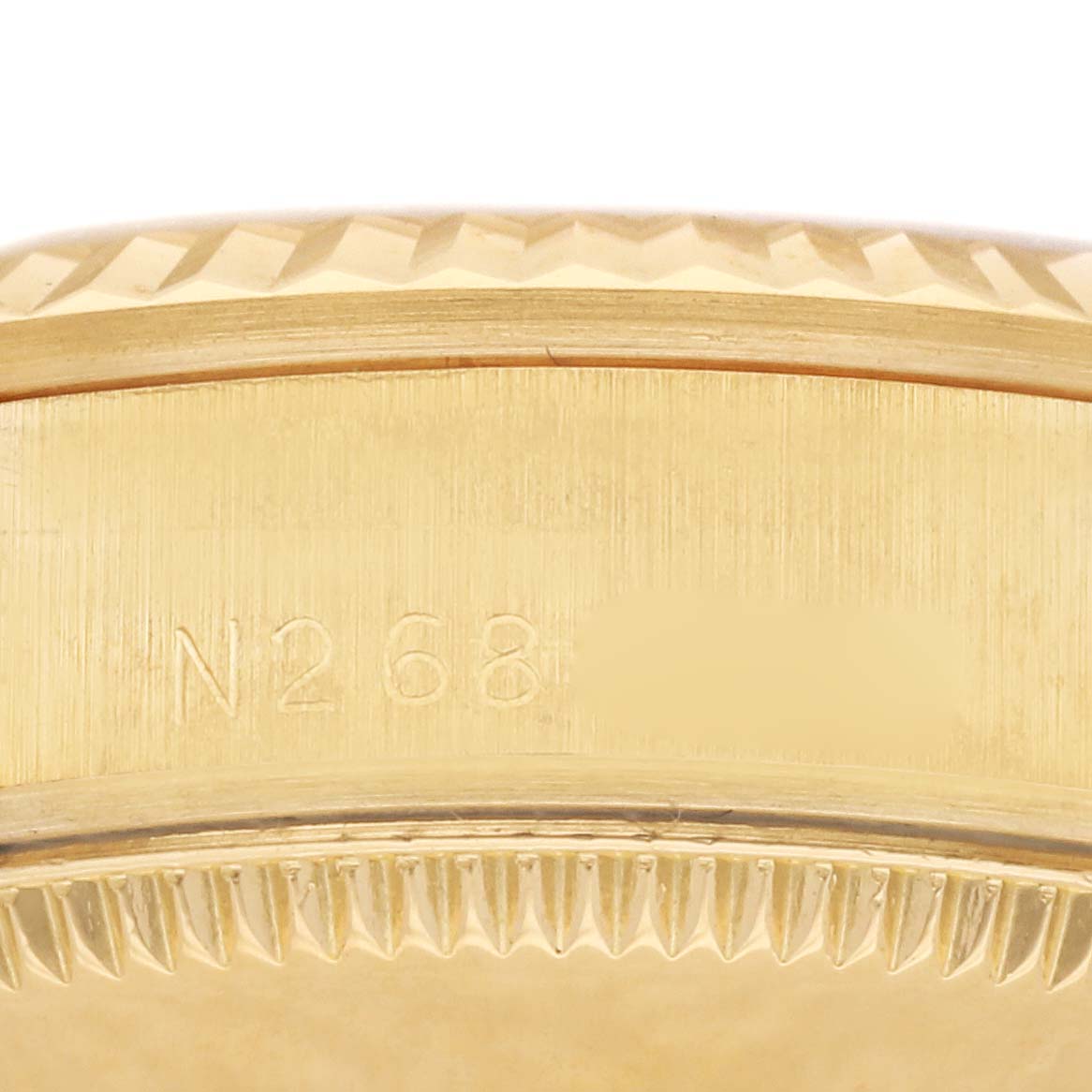 The image shows a close-up of the side casing with engravings from a Rolex President 68278 Women's Yellow Gold Champagne Dial 68278 Women's Yellow Gold Champagne Dial model watch.