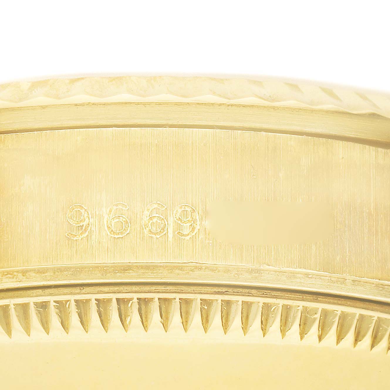 Close-up of the case side of a Rolex President 68278 Women's Yellow Gold Champagne Dial 68278 Women's Yellow Gold Champagne Dial model watch showing its reference number 9669.