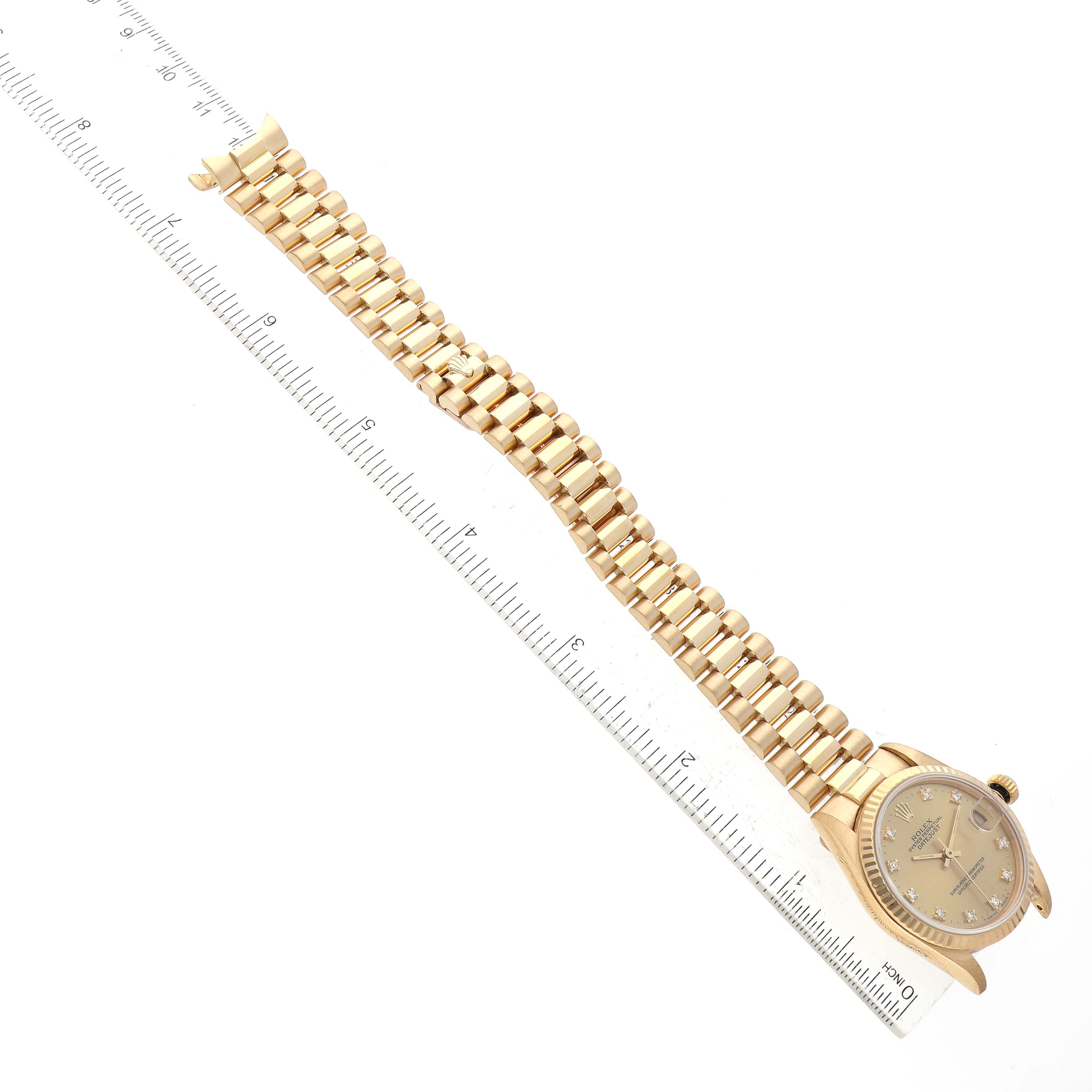 The image shows a Rolex President 68278 Women's Yellow Gold Champagne Dial 68278 Women's Yellow Gold Champagne Dial model watch laid flat, displaying its face and full bracelet alongside a ruler.