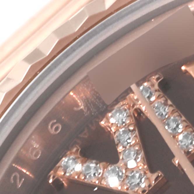 The image shows a close-up of the dial and bezel of a Rolex President 179175 Women's Rose Gold Brown Dial 179175 Women's Rose Gold Brown Dial watch, highlighting the diamond-encrusted Roman numeral hour marker.