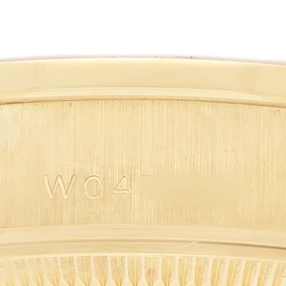 The image shows a close-up of the engraved inner bezel of a Rolex President 69158 Women's Yellow Gold Mother of Pearl Dial watch.