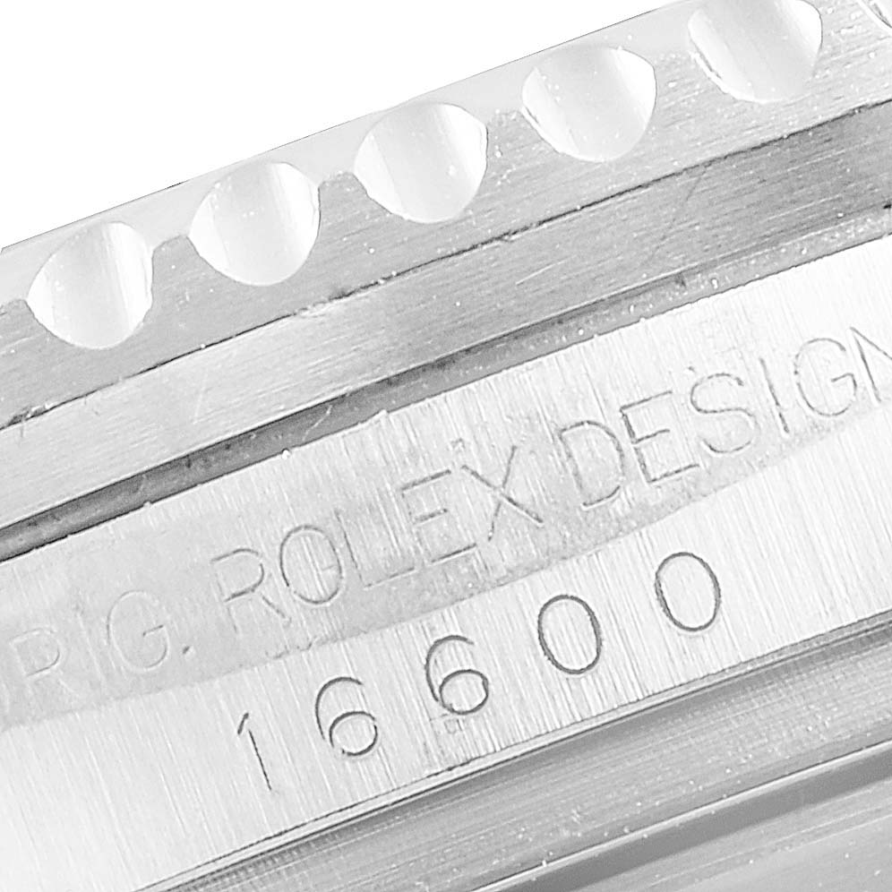 This image shows a close-up of the case side and part of the bezel of a Rolex Sea-Dweller 16600 Men
s Stainless Steel Black Dial 16600 Men
s Stainless Steel Black Dial model, focusing on the "ROLEX DESIGN" engraving and model number 16600.
