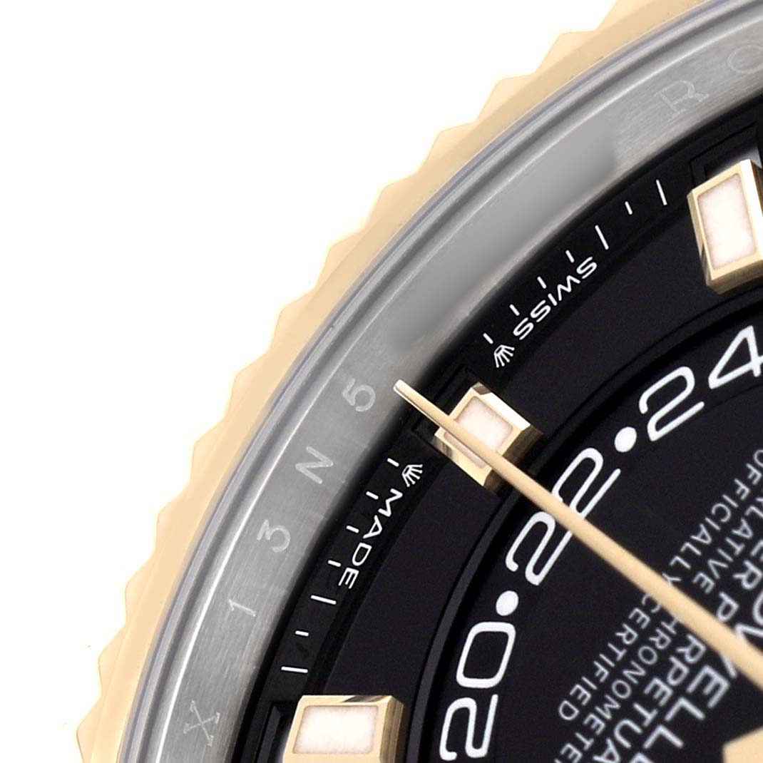 The image shows a close-up angle of the Rolex Sky-Dweller 336933 Men's Steel and Gold (two tone) Black Dial watch face, including part of the bezel and dial with an hour marker and the hands.