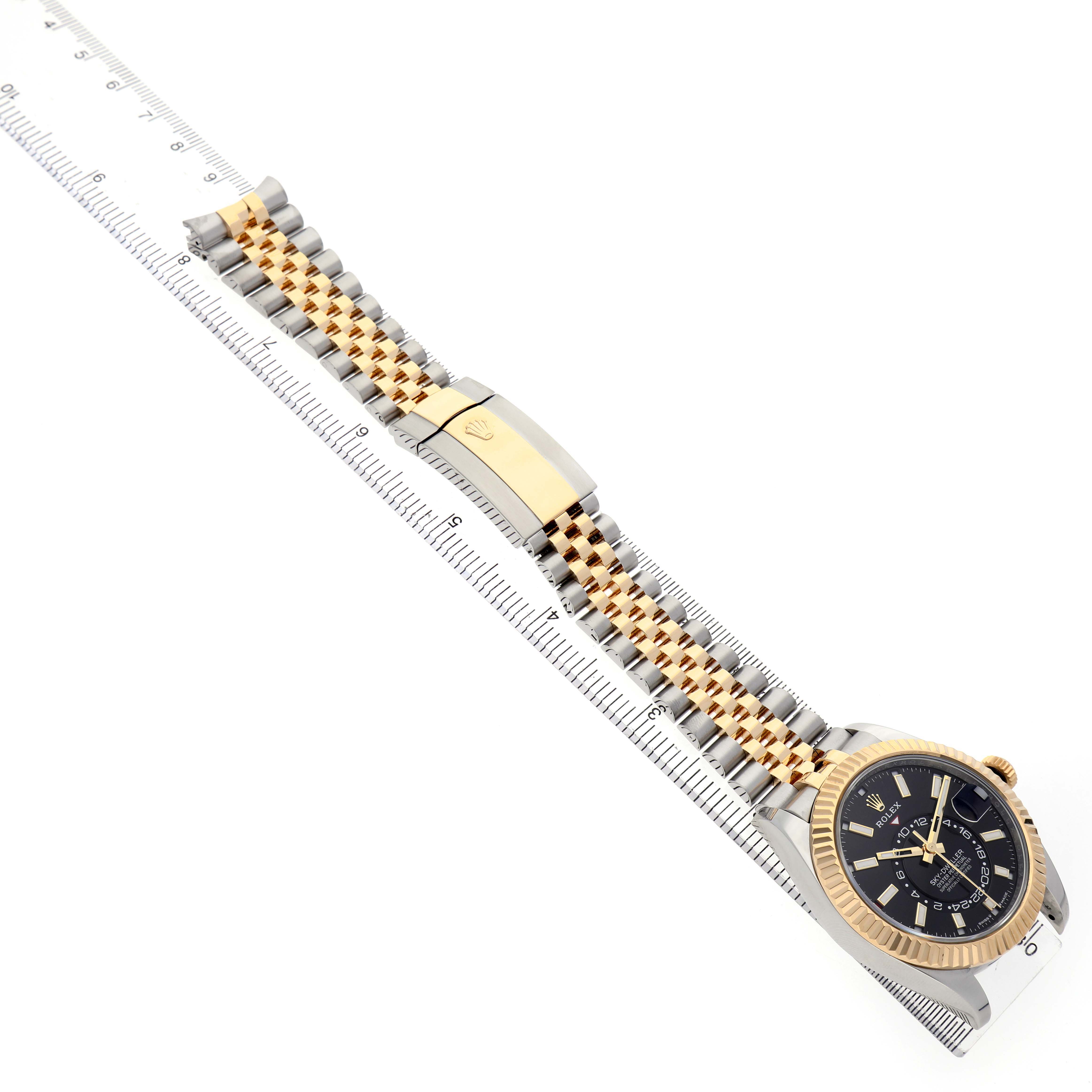 The Rolex Sky-Dweller 336933 Men's Steel and Gold (two tone) Black Dial watch is shown at an overhead angle, displaying the face, bezel, bracelet, and clasp.