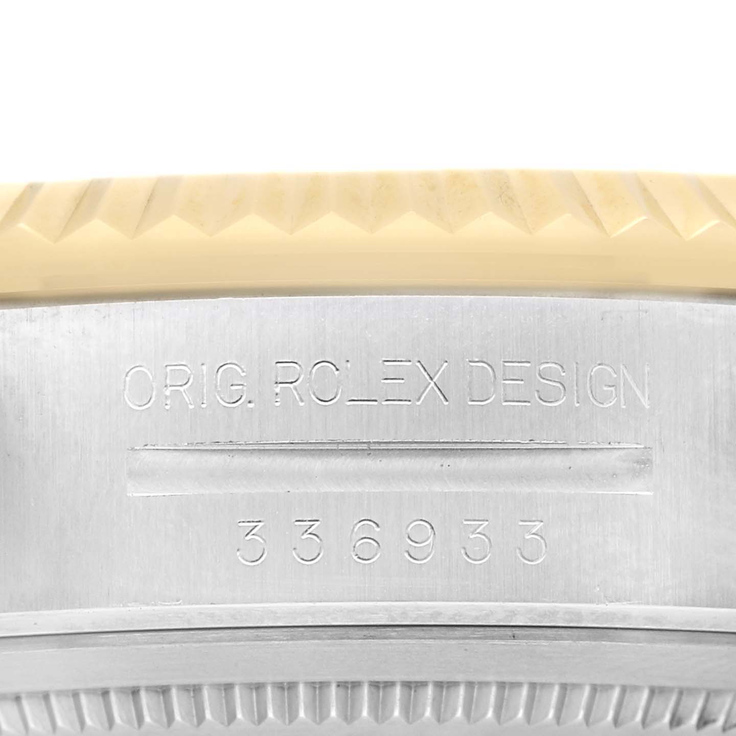 This image shows a close-up of the Sky-Dweller model by Rolex, focusing on the side of the bezel and engraved serial number.