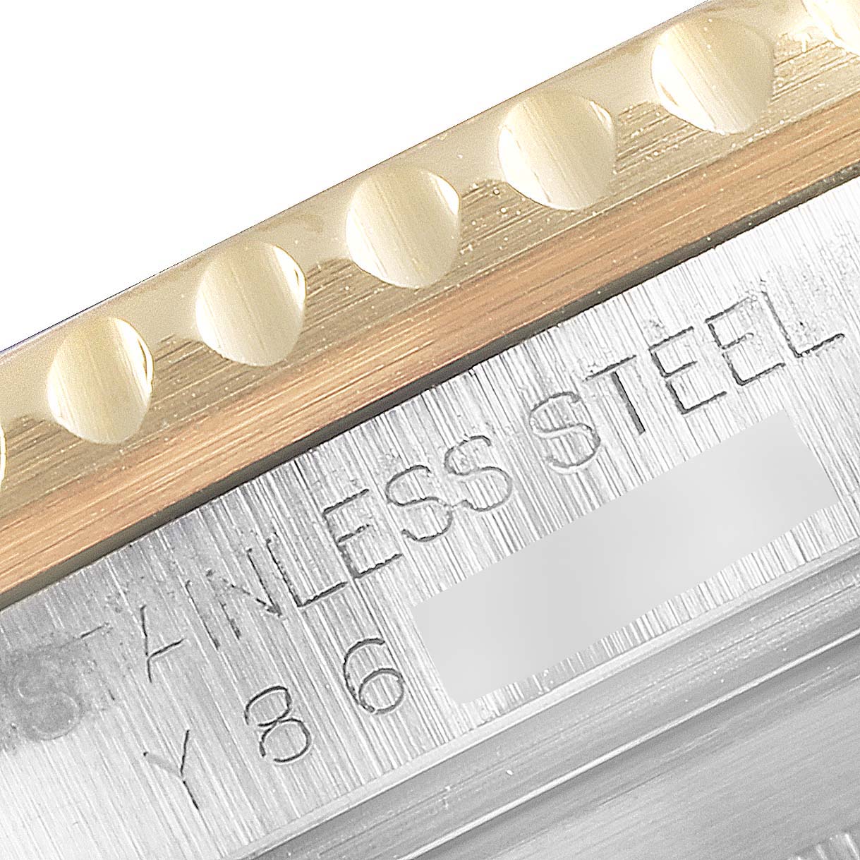 This image shows a close-up of the bezel and part of the case of a Rolex Submariner 16613 Men
s Steel and Gold (two tone) Blue Dial 16613 Men
s Steel and Gold (two tone) Blue Dial watch with "STAINLESS STEEL" engraved.