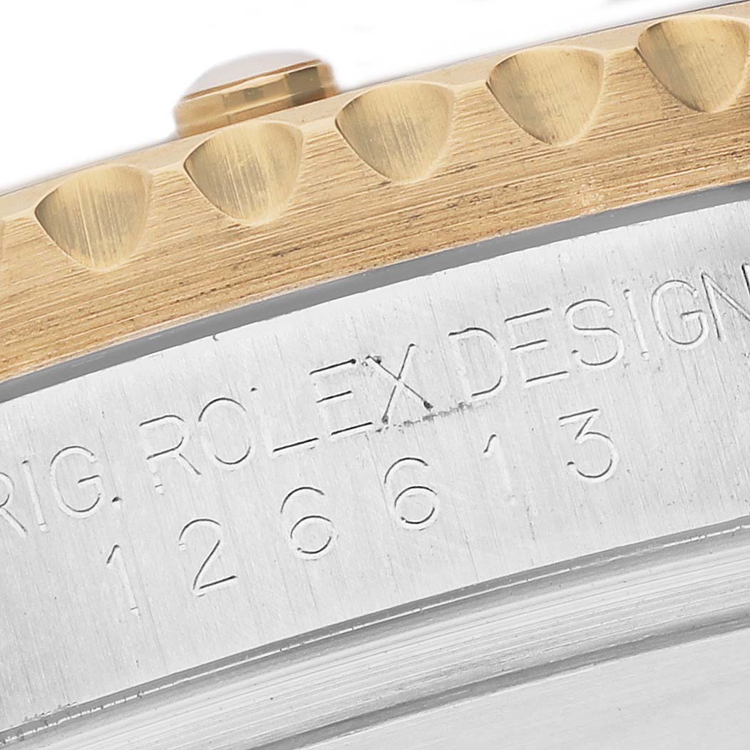 This image shows a close-up of the side of the bezel and case, revealing the engraving on a Rolex Submariner 126613LN Men's Steel and Gold (two tone) Black Dial 126613LN Men's Steel and Gold (two tone) Black Dial watch.