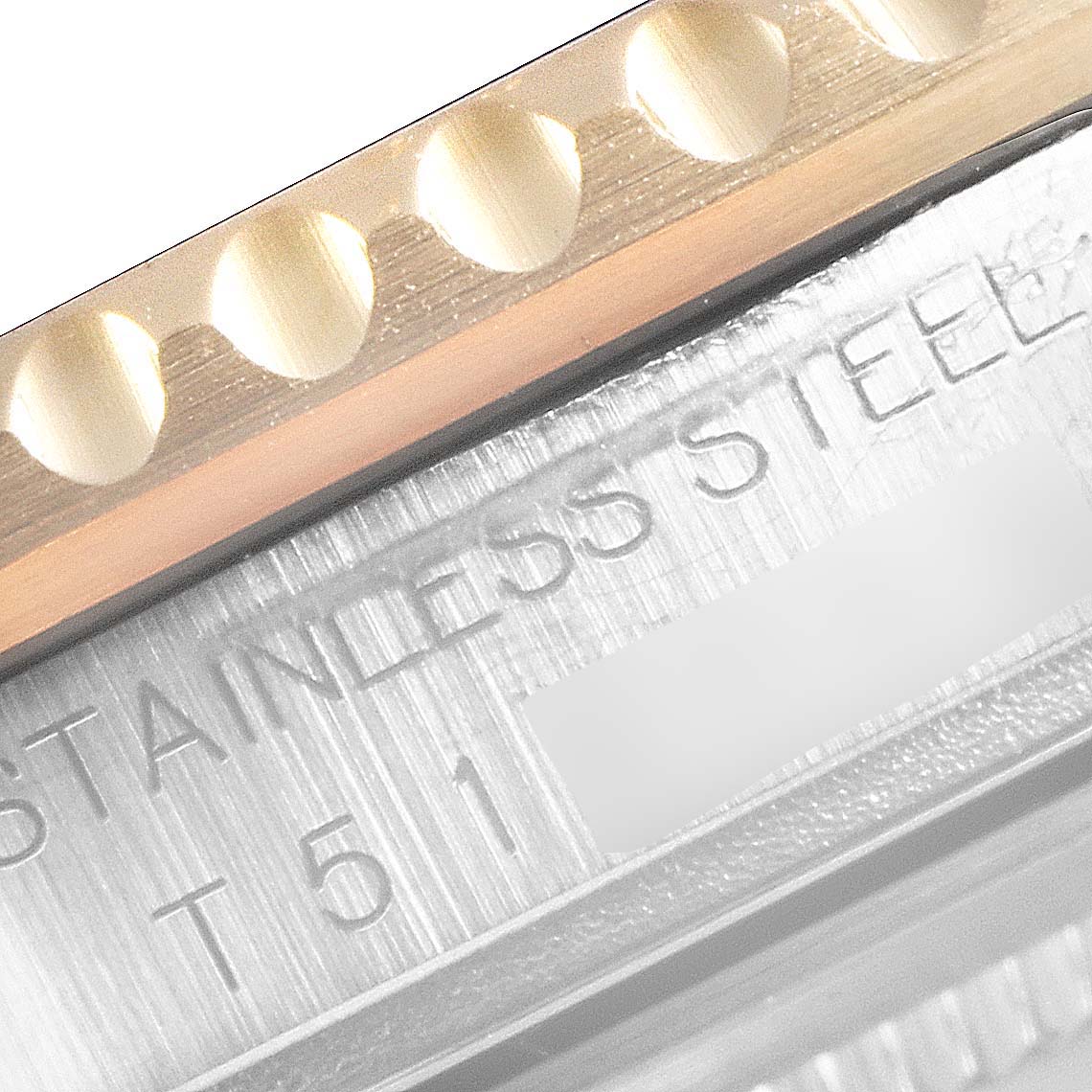 This image shows a close-up of the bezel and part of the engraving on a Rolex Submariner 16613 Men
s Steel and Gold (two tone) Blue Dial 16613 Men
s Steel and Gold (two tone) Blue Dial watch, highlighting the "STAINLESS STEEL" marking.