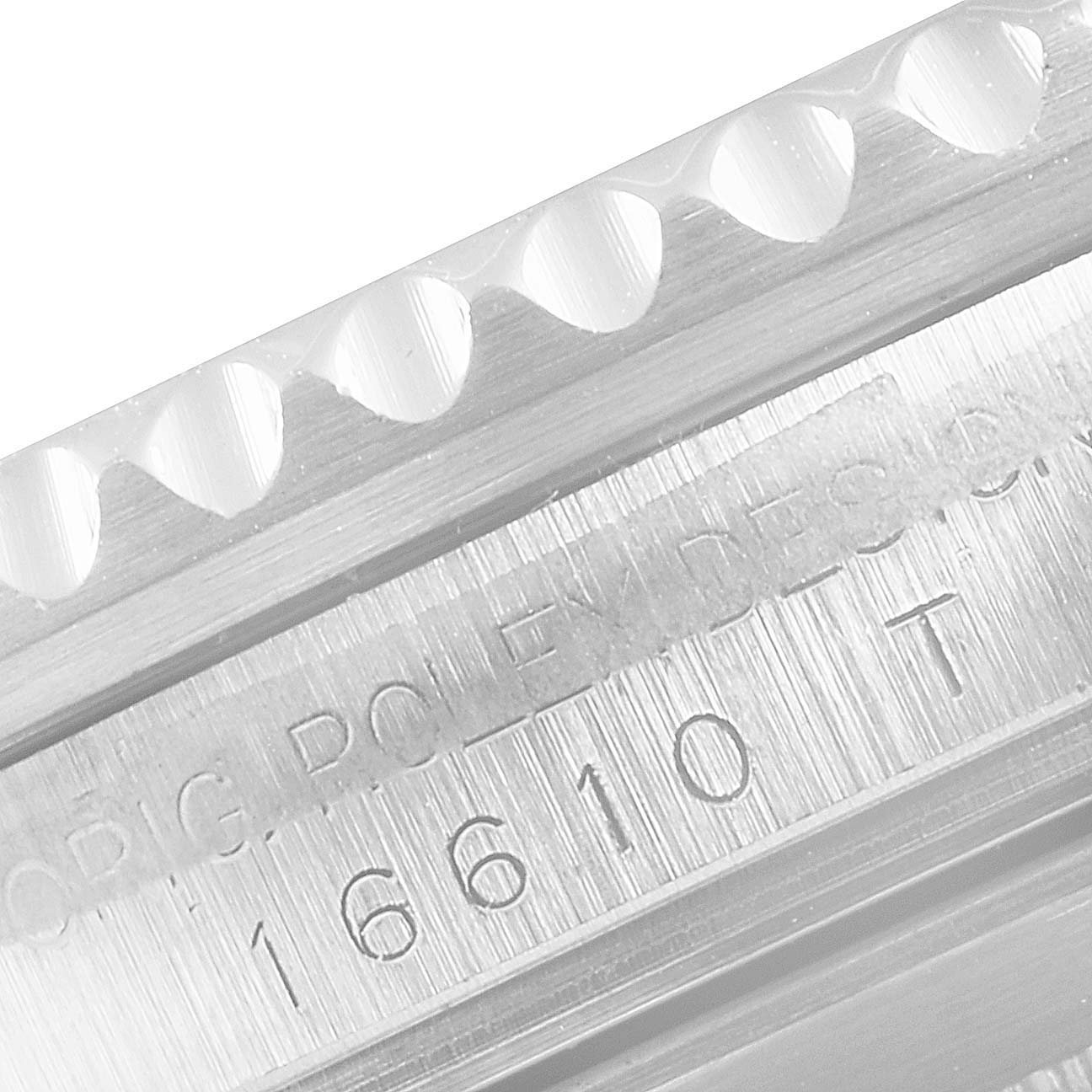 This close-up image of the Rolex Submariner 16610 Men's Stainless Steel Black Dial 16610 Men's Stainless Steel Black Dial watch shows a detailed view of the rehaut engraving and the edge of the bezel.