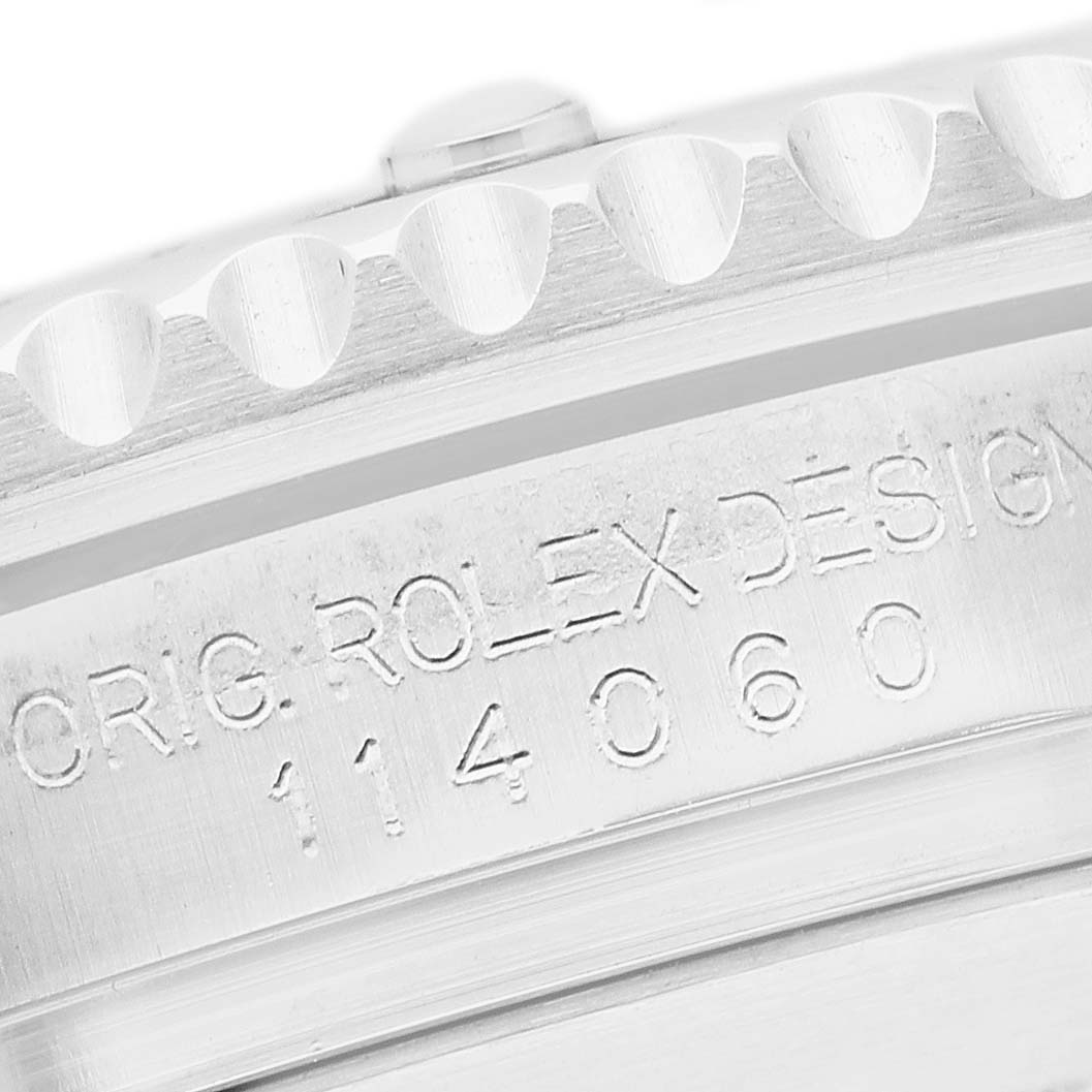 The image shows the side view of a Rolex Submariner 114060 Men's Stainless Steel Black Dial's case, focusing on the engraved serial number and design details.