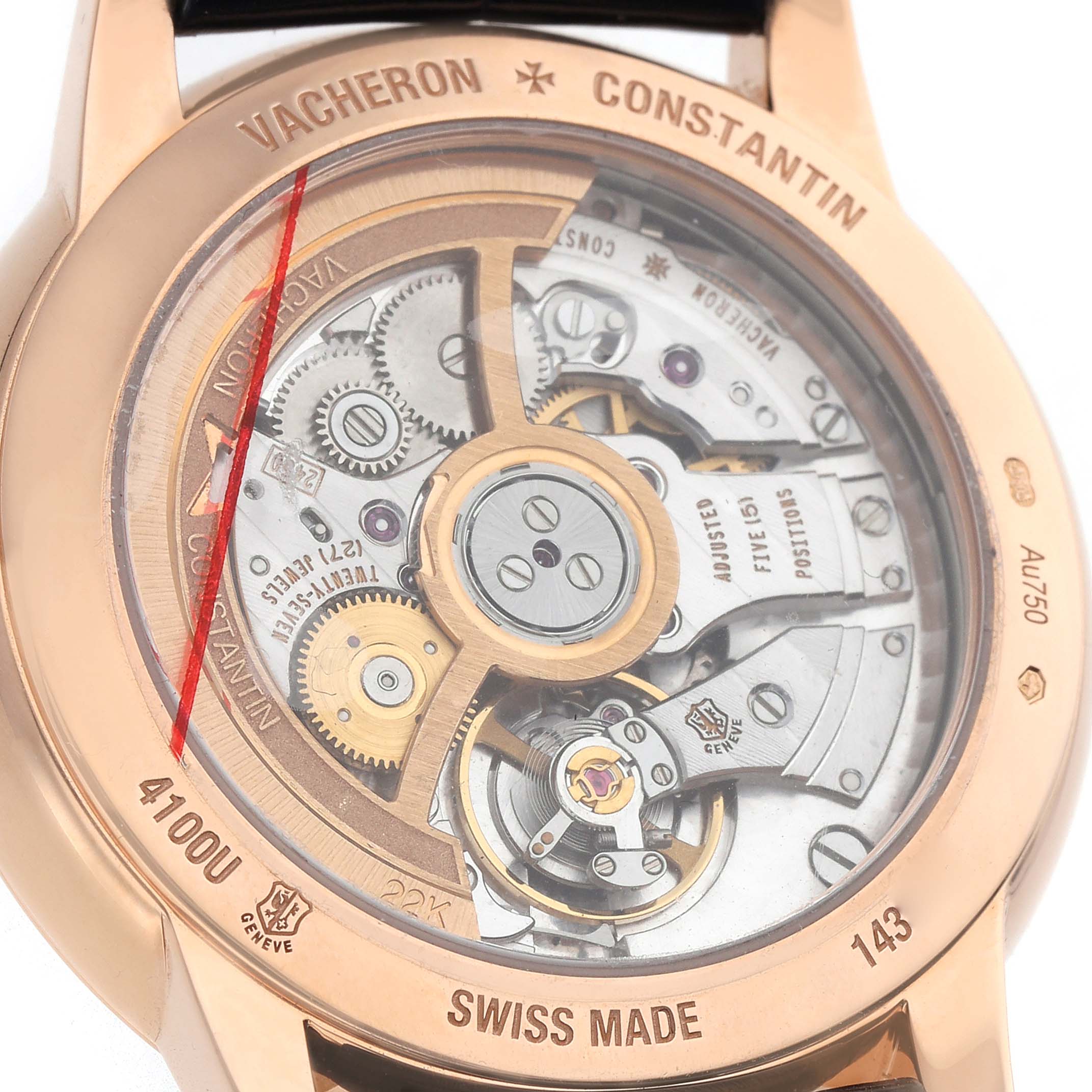 The image shows the back of a Vacheron Constantin Patrimony 4100U Men's Rose Gold Blue Dial watch, revealing its intricate mechanical movement with visible gears.