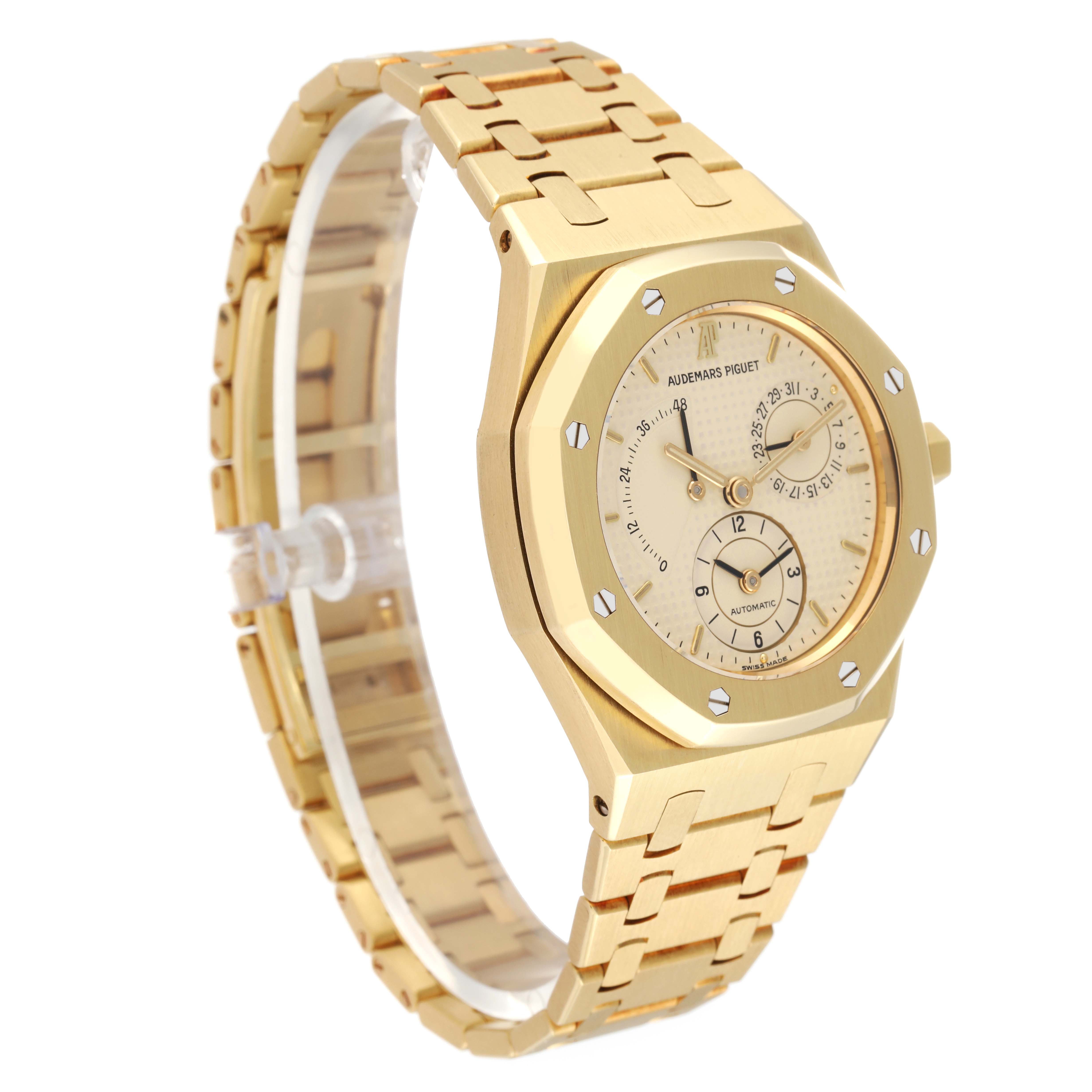 The image shows a side view of an Audemars Piguet Royal Oak 25730BA Men
s Yellow Gold Silver Dial 25730BA Men
s Yellow Gold Silver Dial watch, highlighting its gold case, bezel, dial, and bracelet.