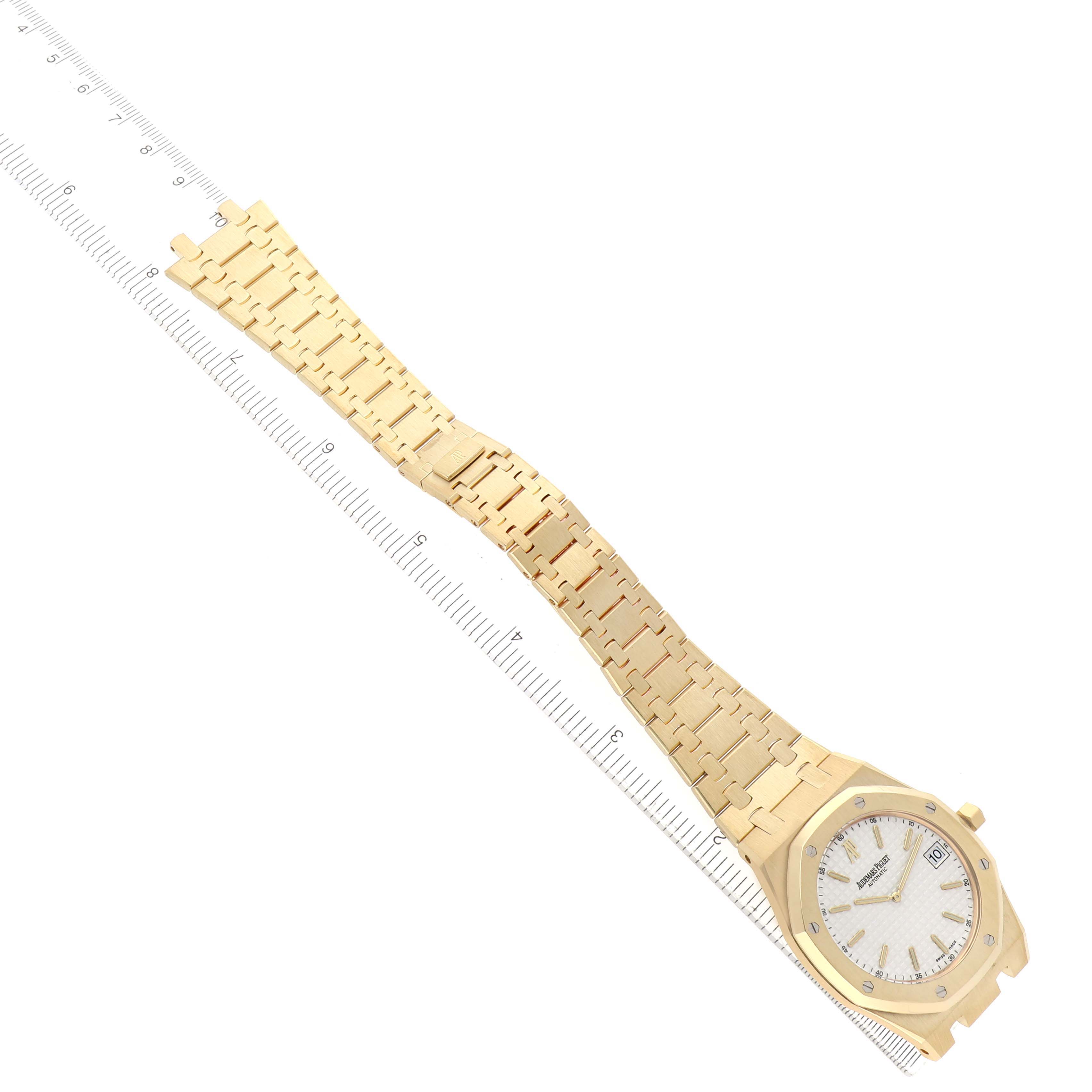 The Audemars Piguet Royal Oak 15202BA.OO.0944BA.01 Men's Yellow Gold White Dial watch is shown from a top-down angle, displaying the face, bracelet, and part of the clasp.