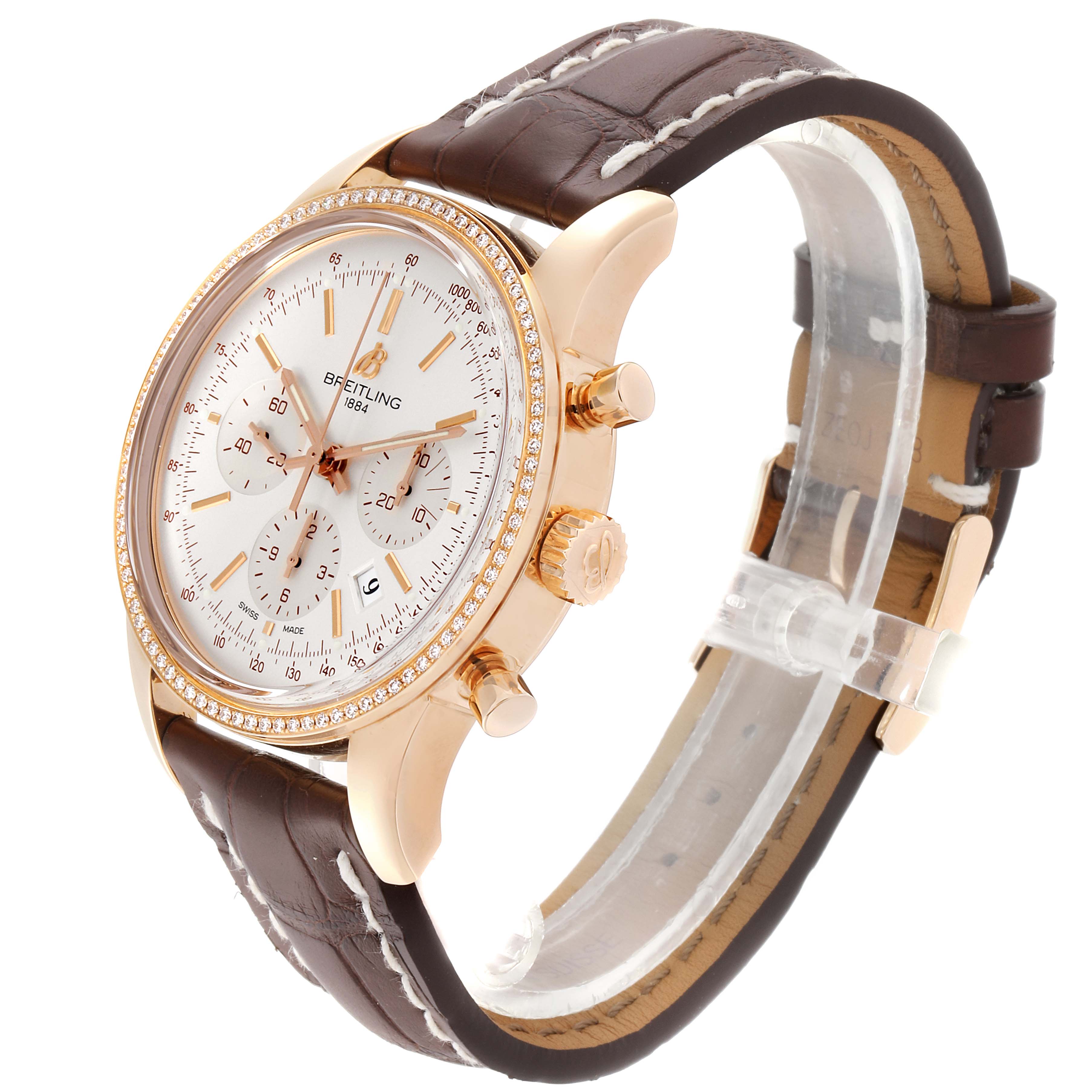 The image shows a side view of a Breitling Transocean RB0152 Men's Rose Gold Silver Dial RB0152 Men's Rose Gold Silver Dial wristwatch, highlighting the face, crown, pushers, and brown leather strap.