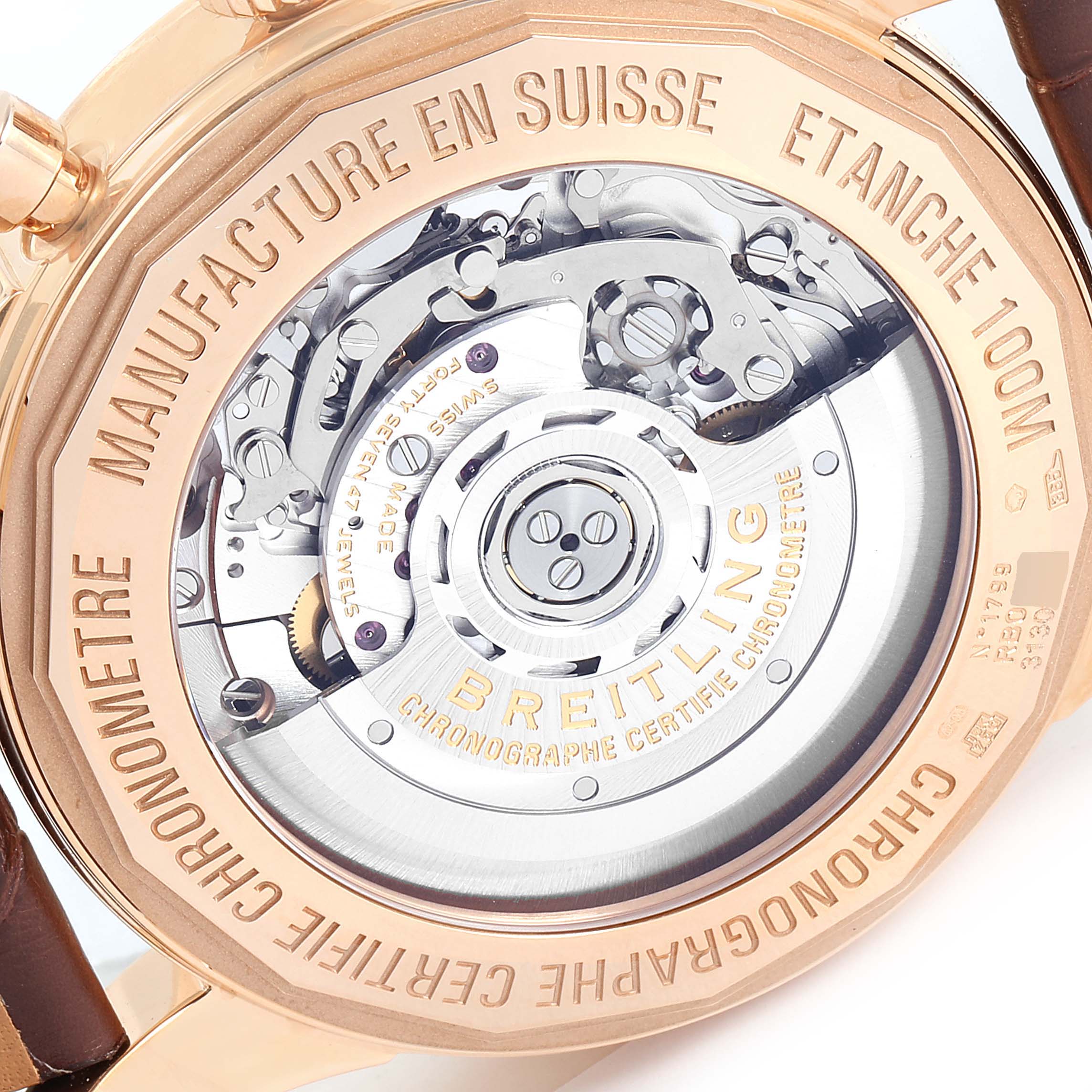 This image shows the back view of the Breitling Transocean RB0152 Men's Rose Gold Silver Dial RB0152 Men's Rose Gold Silver Dial watch, highlighting its mechanical movement and engravings.