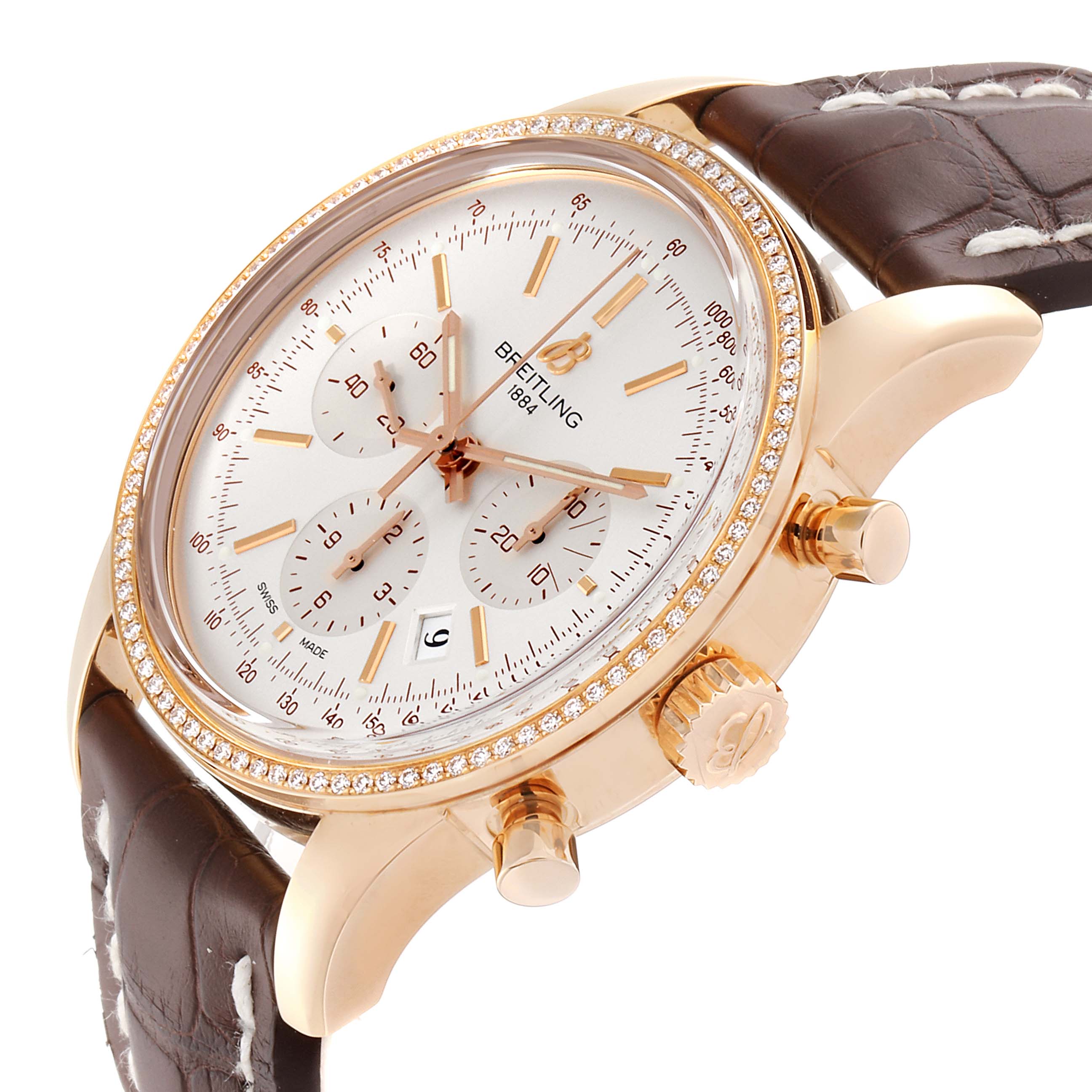 The image shows a side-angle view of a Breitling Transocean RB0152 Men's Rose Gold Silver Dial RB0152 Men's Rose Gold Silver Dial watch, highlighting its face, bezel, and leather strap.