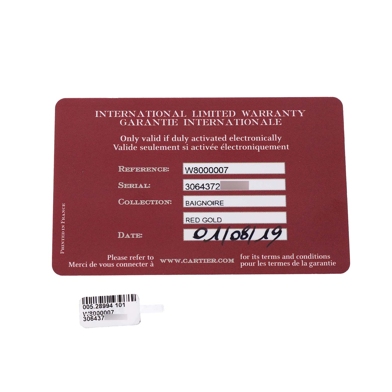 The image shows a Cartier Baignoire W8000007 Women's Rose Gold Silver Dial watch's International Limited Warranty card and a small label with reference and serial numbers.