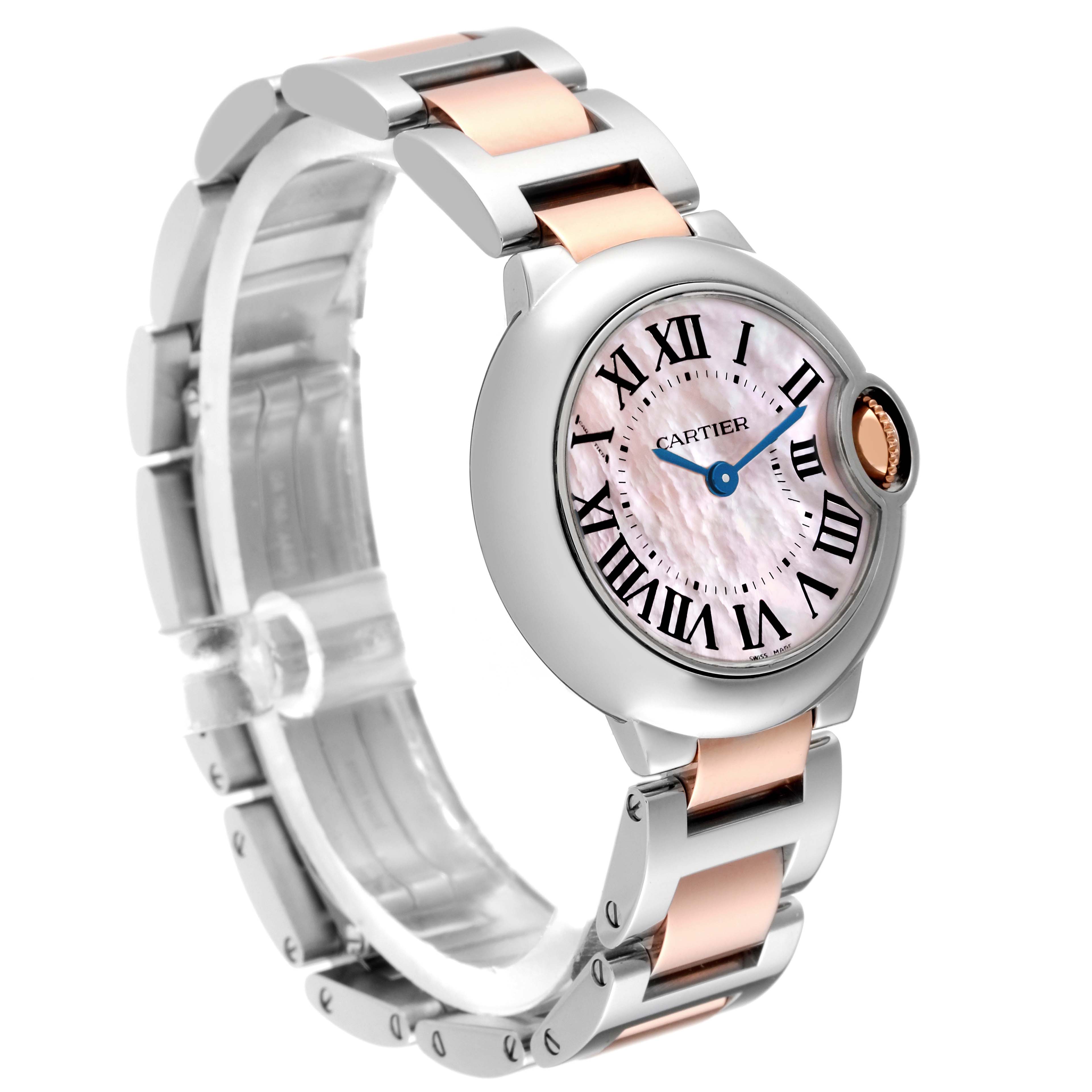 This image shows a Cartier Ballon Bleu W6920034 Women's Steel and Gold (two tone) Mother of Pearl Dial W6920034 Women's Steel and Gold (two tone) Mother of Pearl Dial watch angled to display its face, Roman numerals, blue hands, and a two-tone metal bracelet.
