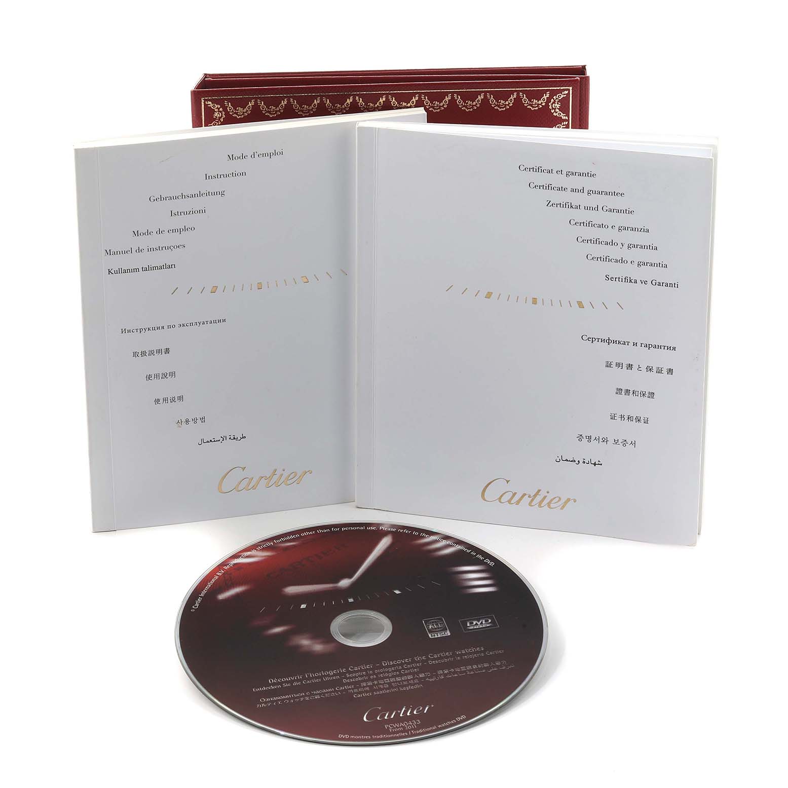 The image shows Cartier Ballon Bleu W6920034 Women's Steel and Gold (two tone) Mother of Pearl Dial watch accessories, including booklets and a CD, viewed from the front.